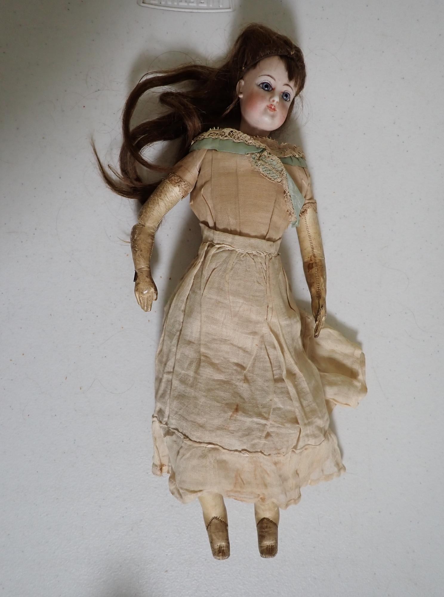 Pres. McKinley's niece's porcelain doll: Porcelain doll with leather body. Has note accompanying it. "Jan. 9th 1963. Dear Elizabeth, This doll was give to me by my Beloved Father who brought it to me from France. He brought it over in 1876.