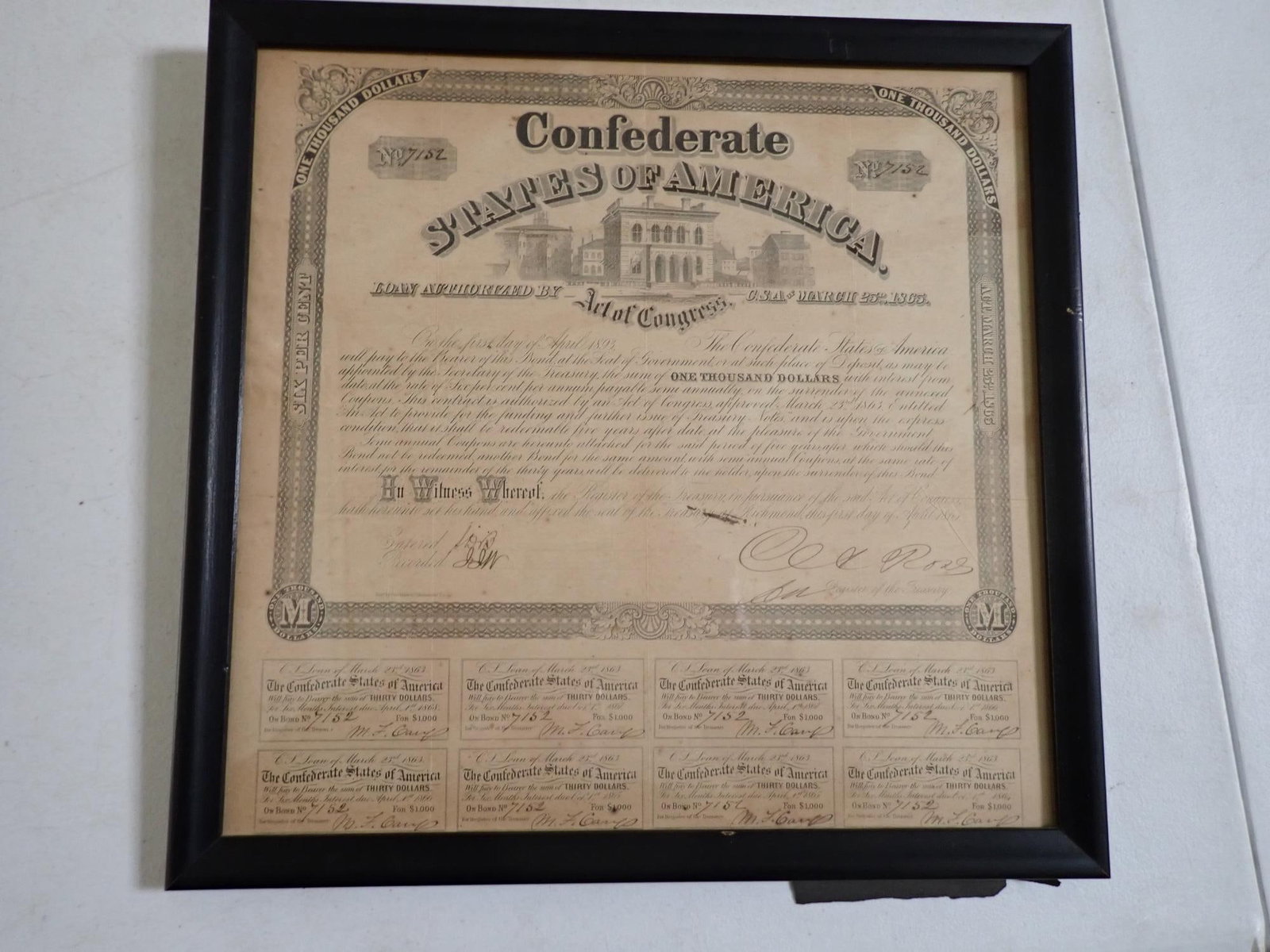 1865 Confederate States of America $1,000 Bond: Today Authorized by Act of Congress CSA March 25th, 1865." Framed bond with 8 Thirty Dollar certificates. Some creasing and stain near signature. Overall, good condition. Frame 14 1/2" x 15.