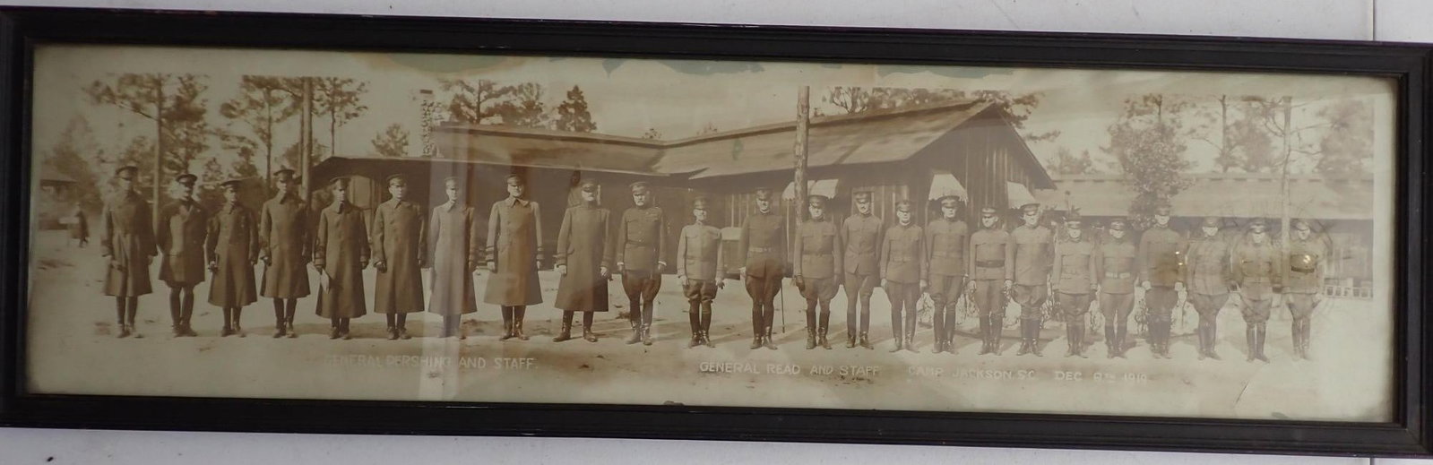 Panoramic photo Gens. Pershing, Read & Staff Camp Jackson, SC- Dec 6th, 1919: Photo shows Gen. Blackjack Pershing and other. Frame 3' wide x 9" high. Has tear in lower right and some staining along top edge.
