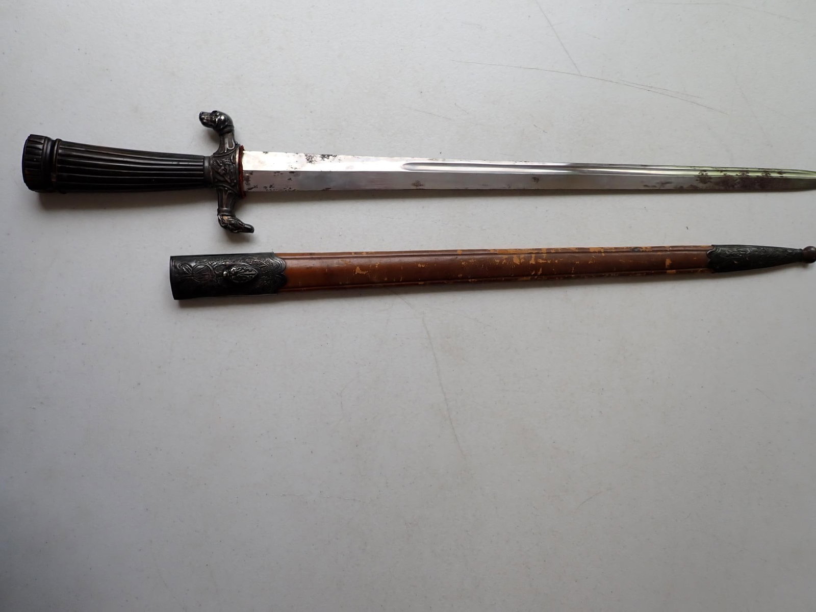 Couteau de Chasse Dog Design Sword: French couteau de chasse by Coulaux Ain? c1838-1840. The 26" sword has a 20" inch long blade. Stylish horn hilt, tapering into vertical ribs from the crenellated pommel to an elaborate cast crossbar