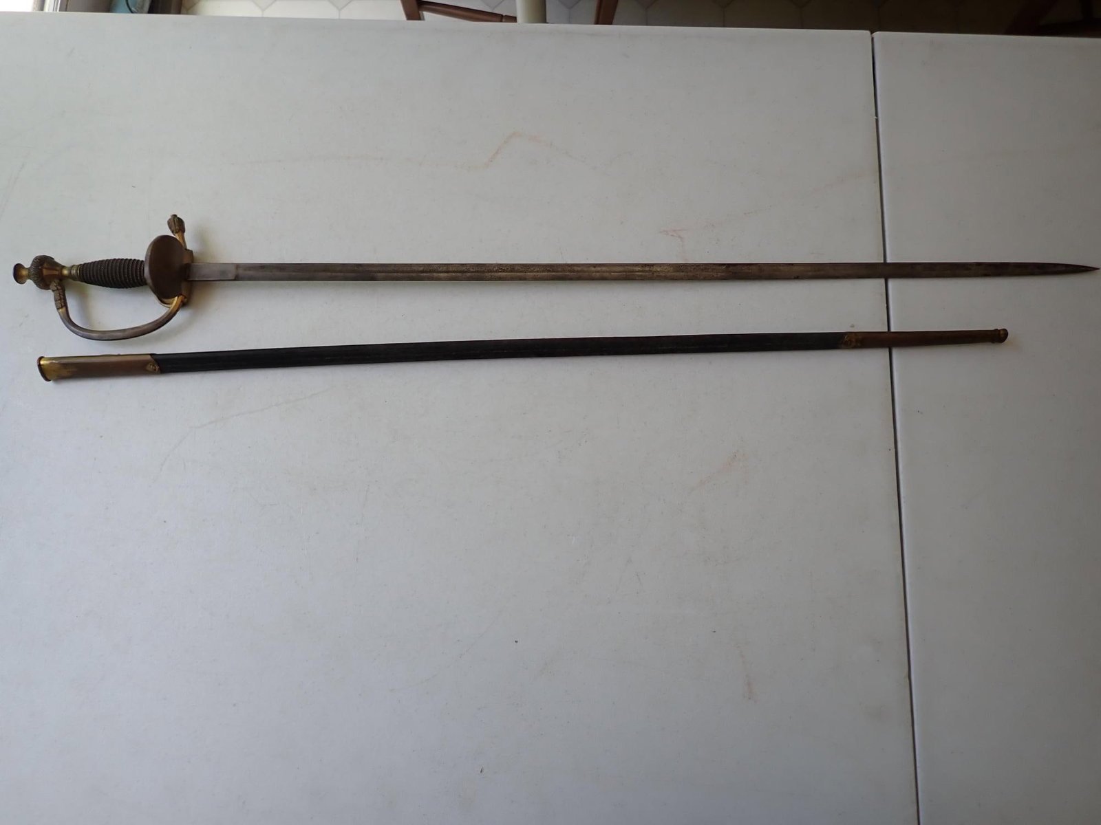 Prussian Infantry Officer's Sword: 36" length. Blade 30 1/4." Blade has discoloration. No maker's mark discernible on blade. Blade doesn't slide in completely. Approximately 1/2" exposed.