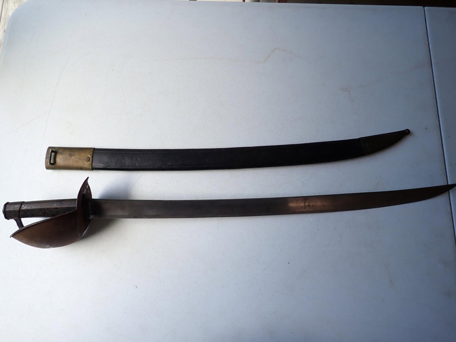 Early to mid- 19th century French Naval Cutlass: 32" length. 26 1/2" blade. Some surface rust but overall good condition.