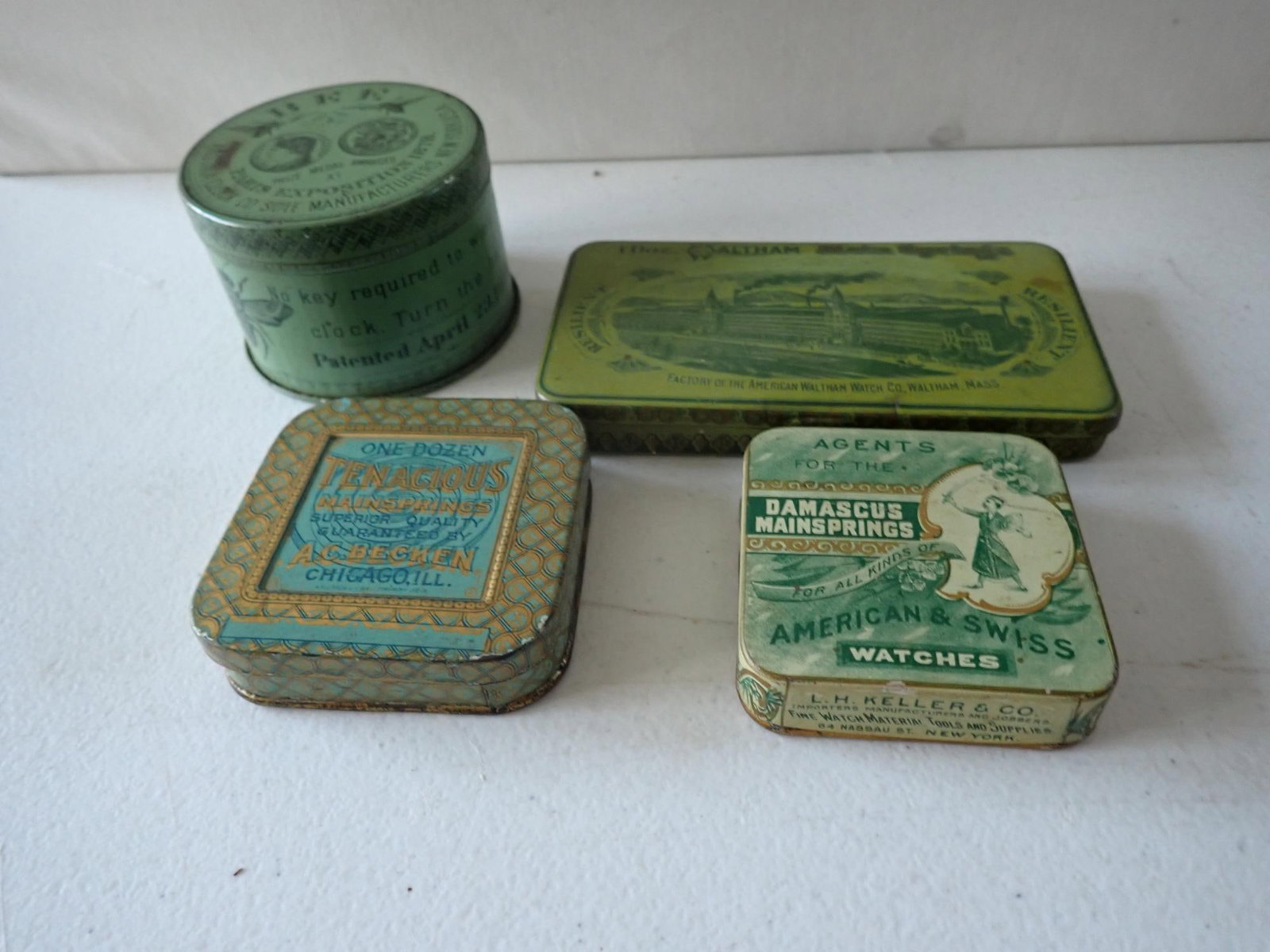 One Day Bee Ansonia Clock Tin & Watch Tins: Ansonia Bee Clock tin largest 3" diameter x 2" high. Damascus Watch Main Sprins smallest 2 1/2" x 2 1/2"