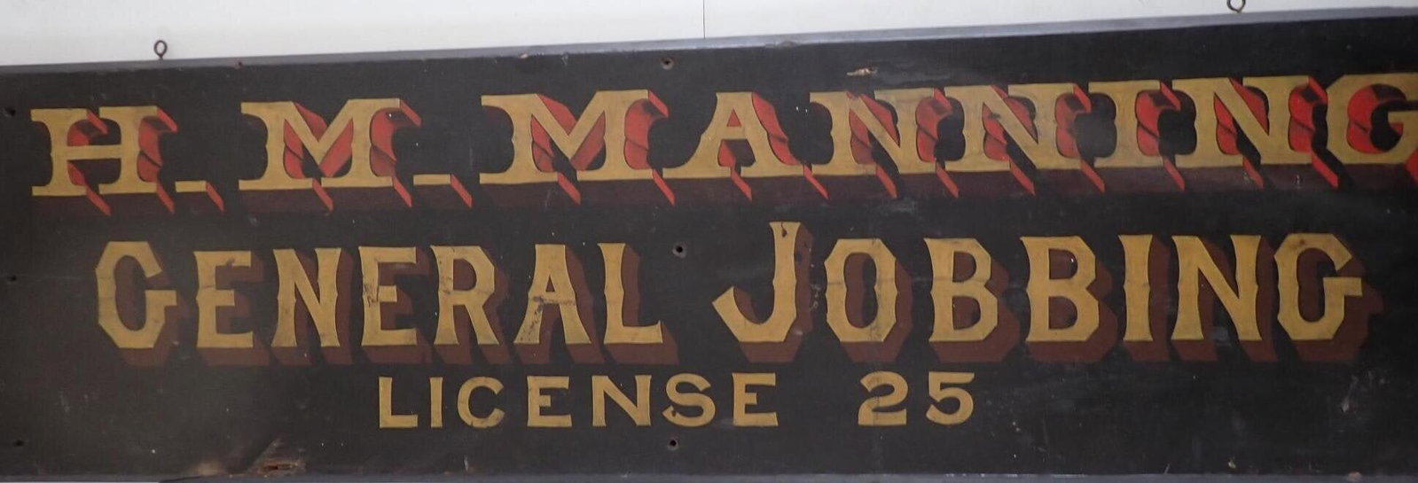 H.M. Manning General Jobbing Wooden Sign: Jobber's "License 25". 13" x45". Normal wear for a vintage sign.