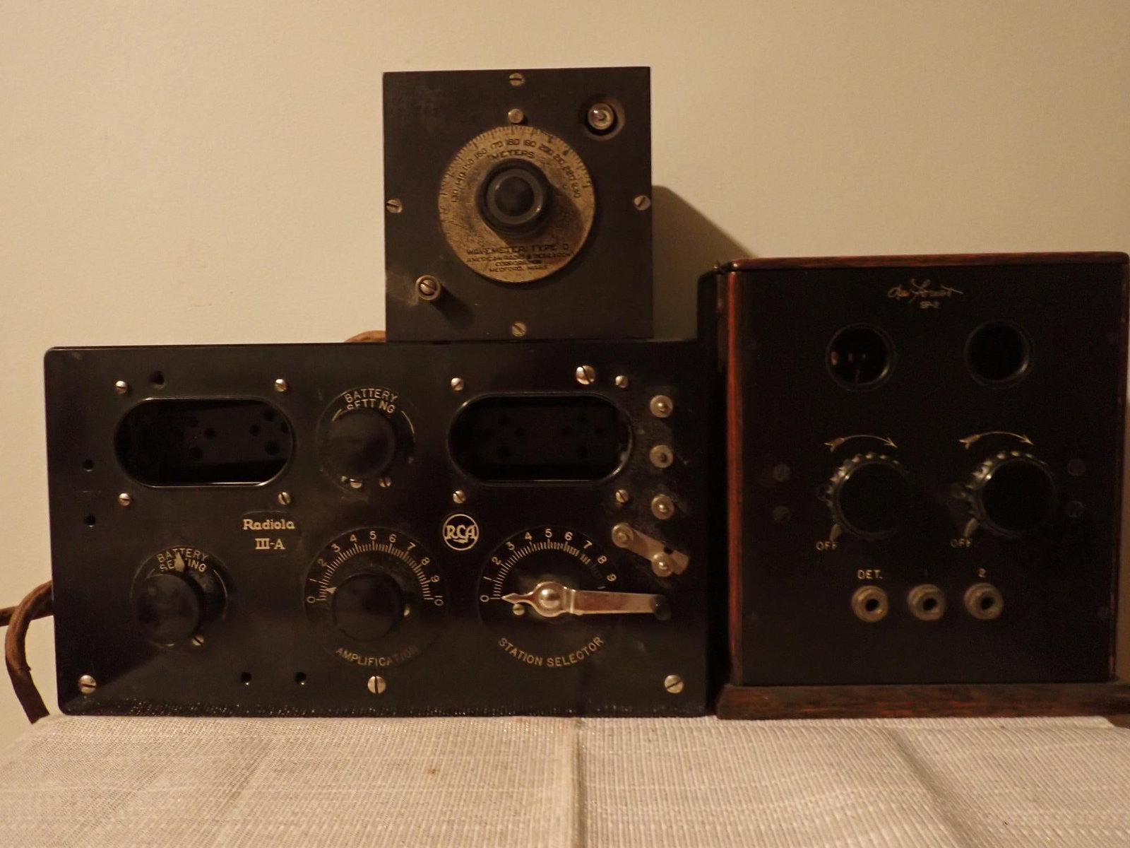 DeForest Radiophone, RCA Radiola Radio, Wavemeter: 3 pieces - RAC Radiola III-A radio, case only no tubes; 11 1/2" x 7" x 4 1/2". Radio-Craft Radiophone SP-2 made by De Forest; latched top of wooden case opens to show 2 tubes; 8" x 7" x 4 1/2". 4