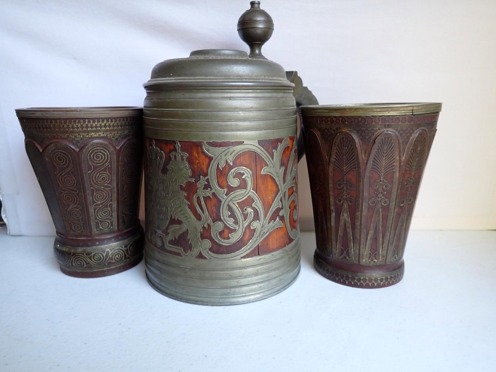 Frans Santesson Swedish Stein & others: This Daubenkrug was made by F. Santesson in the late 1800's and coat of arms of in the center front portion of the pewter design. Also 2 large wooden drinking cups with brass designs. One mug has