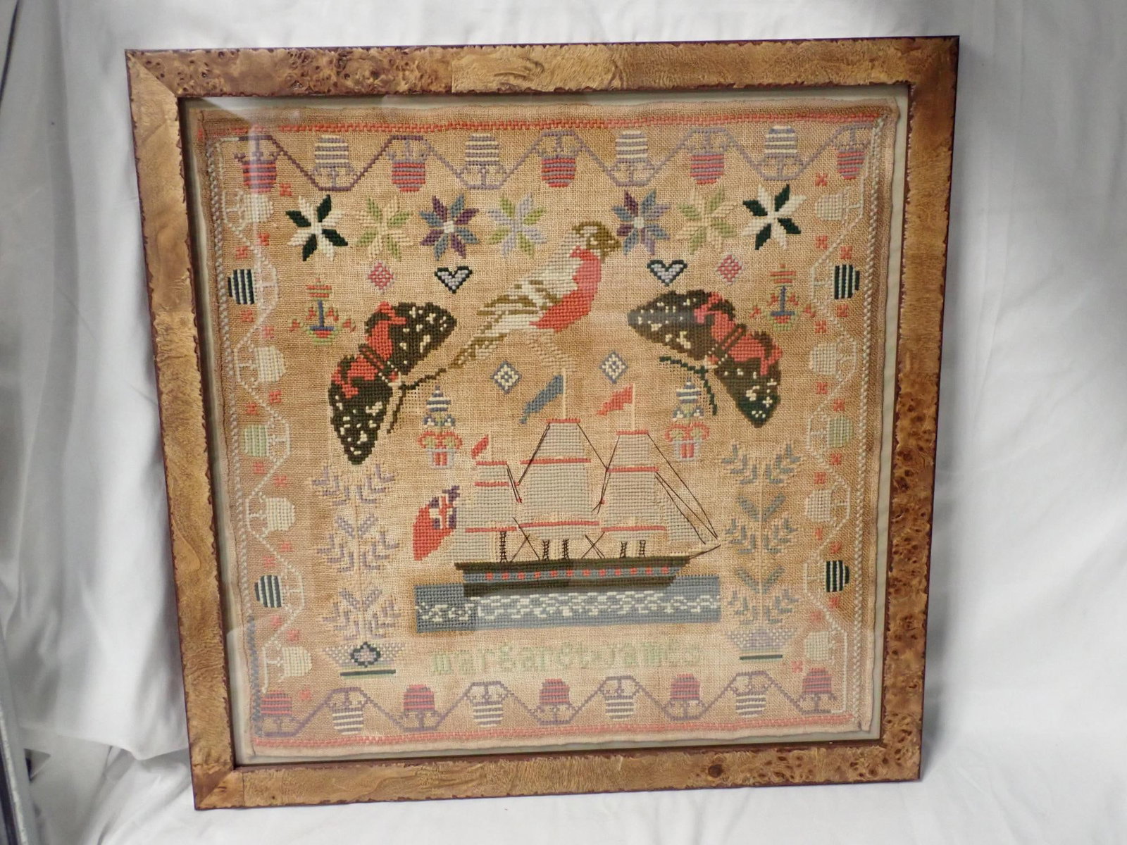 Margaret James Sampler: Sampler with butterflies ship bird lots of foxing on fabric no rips or tears frame 20 1/2" x 20 1/2" Sampler 17 1/2" x 17 1/2." no date
