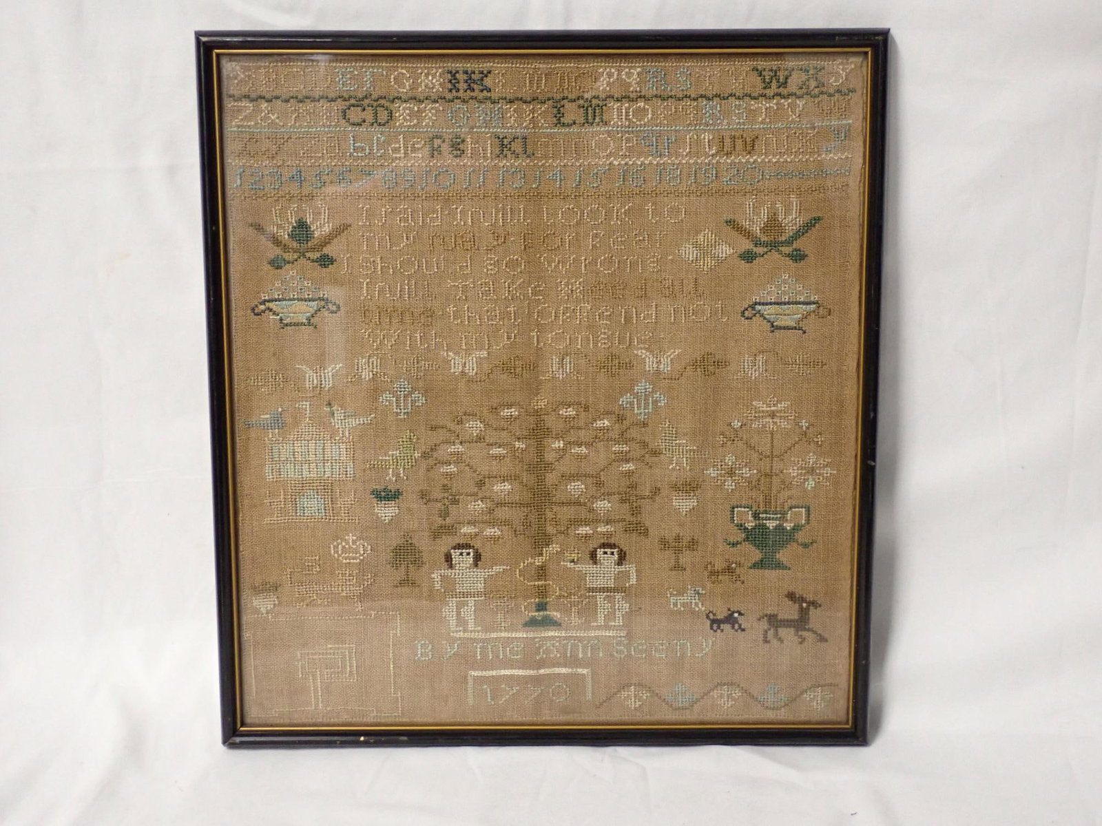 1770 Ann Seeny sampler: By me Ann Seeny 1770, alphabet and numbers depicting what appears to be Adam and Eve animals birds and other decoration. fabric discoloration otherwise good condition considering its age. Frame 12" x