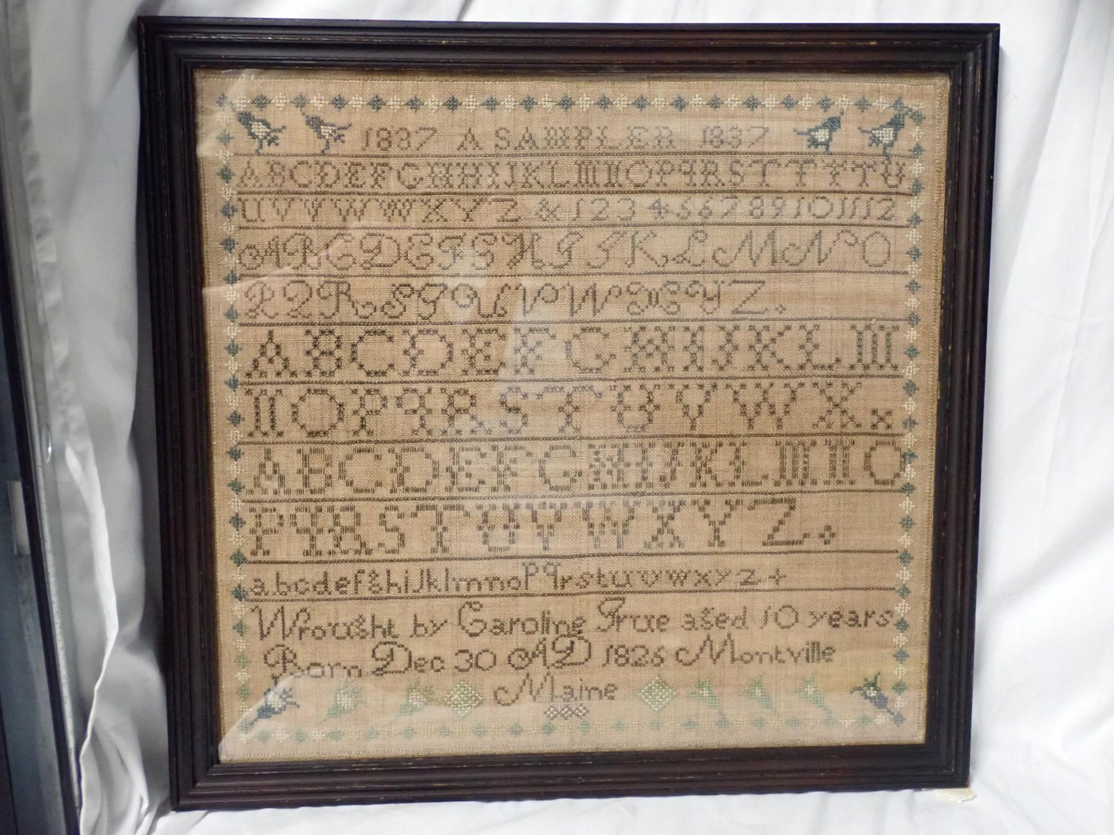 1837 Caroline True Sampler: Titled "1837 A Sampler 1837" Wrought by Caroline True aged 1o years Born Dec 30 AD 1826 Montville Maine Frame 18 1/2" x 19 1/2" Sampler 16 1/2" x 17 1/2"