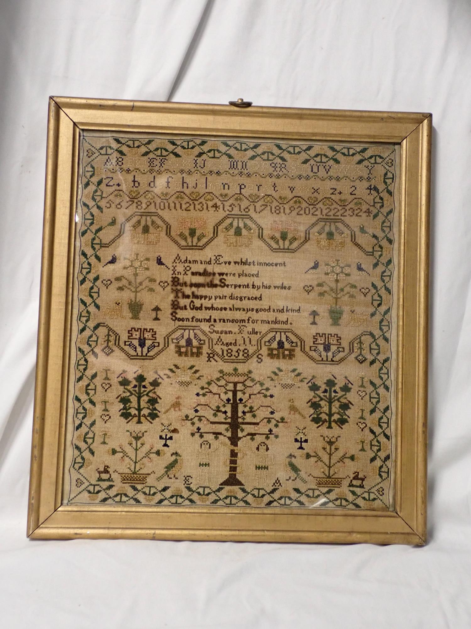1858 Susan Fuller Sampler: Susan Fuller Aged 11 1858 Religious verse in center . Depicting alphabet, numbers, geometric, floral and fauna designs. Some bleeding of dyes and discoloration of fabric Frame 17 1/2" x 15 1/2."