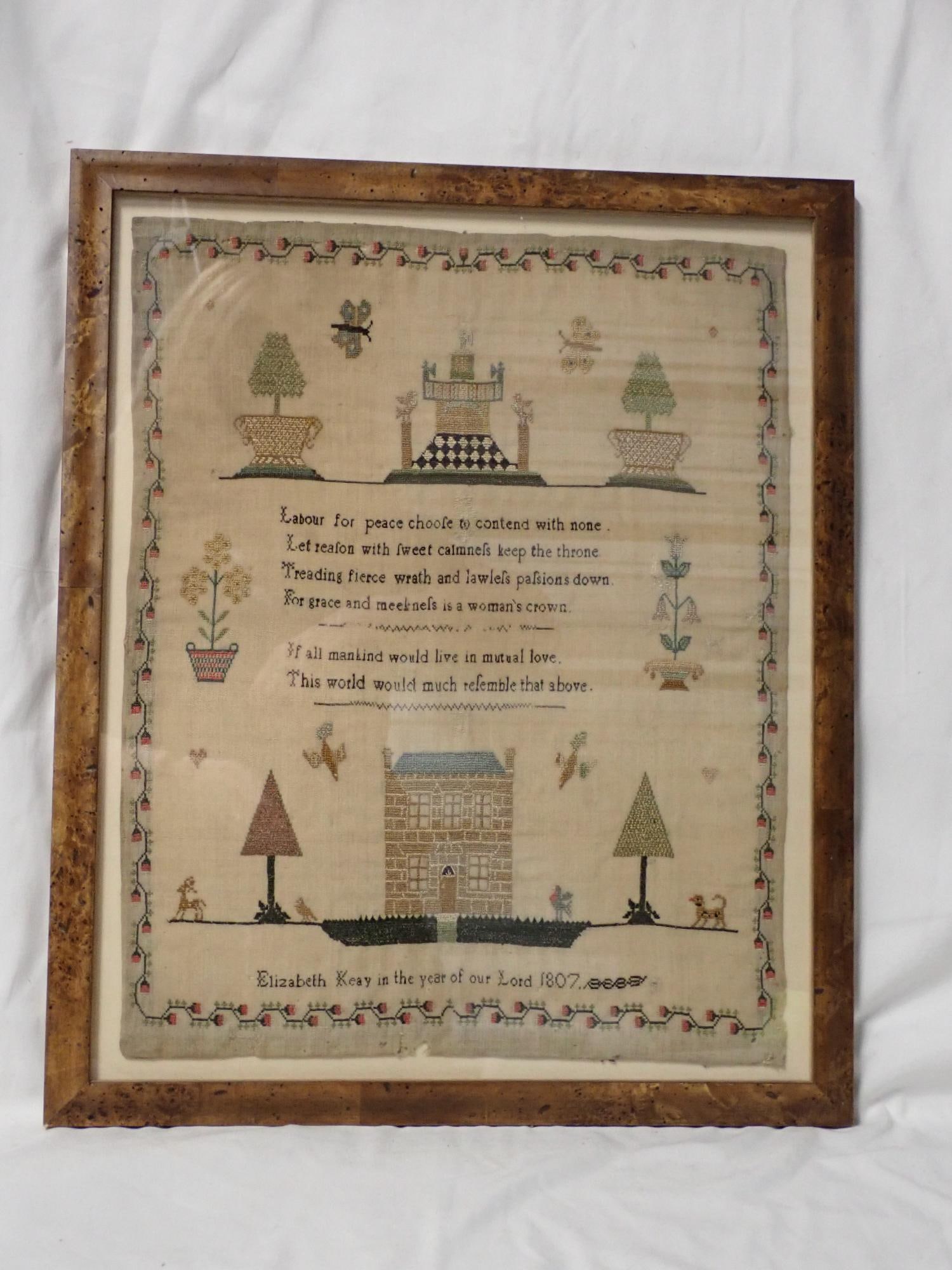 1807 Elizabeth Keay Sampler: Elizabeth Keay in the year of our lord 1807, moral verse in center depicting buildings, butterflies, floral and fauna. Some slight fabric loss and some fabric repairs Frame 17 1/2" x 14 1/2" Sampler