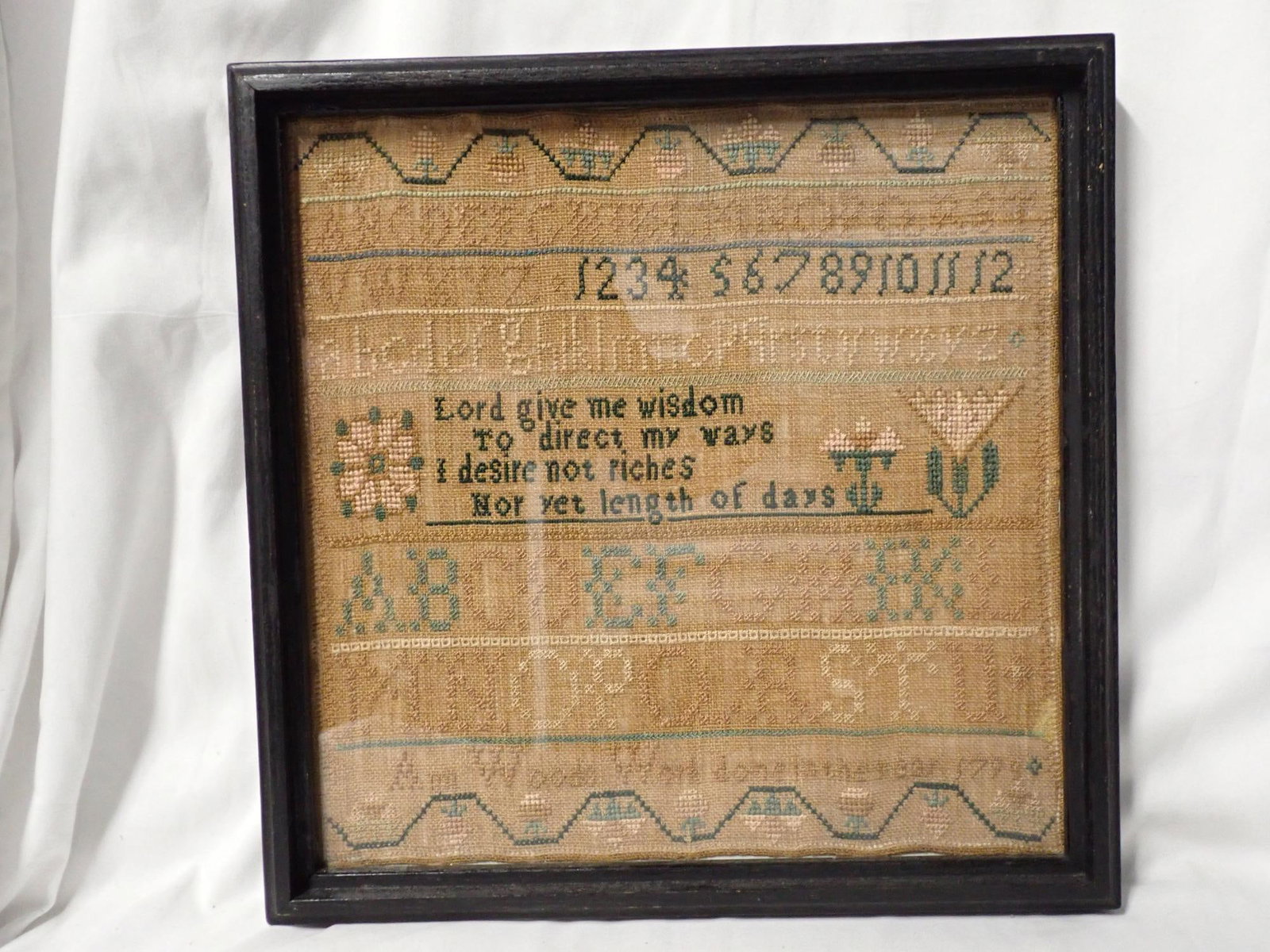 1799 Ann Woods Sampler: Ann Woods Work done in the year 1799 Alphabet and numbers Geometrical vine and floral. Some fabric discoloration. Famed 14" x14" Sampler 12" x 12"
