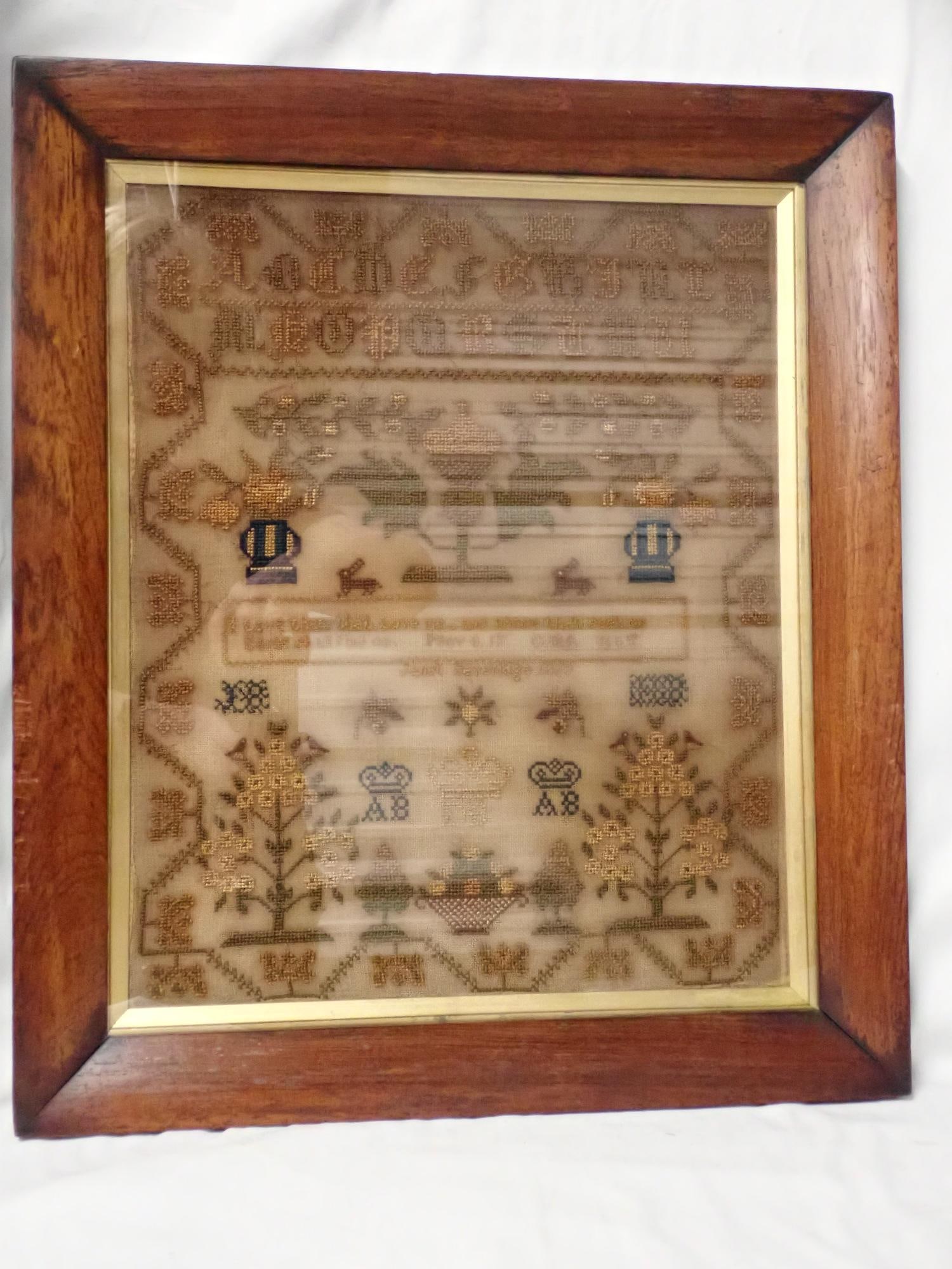 1858 Janet Severide Sampler: Janet Severage Lots of Gold thread. Alphabet floral and rabbit motif religious verse in center. Some dye bleeding and discoloration. Frame 19 1/2" x 17 1/2" Sampler 15 1/2" x 13 1/2"