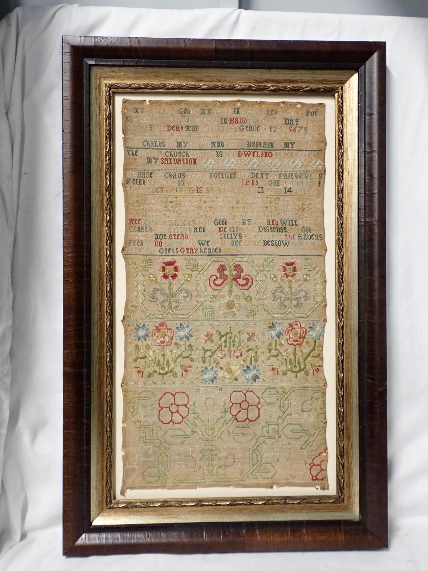 1600(s) Ann Child Sampler/Sampler: Ann Child religious verse at top, Cross Stitch, crewel work floral motif bottom possibly unfinished. staining , fabric loss and fading. Frame 22 1/2" x 14 1/2." Sampler 17 1/2" x 9"