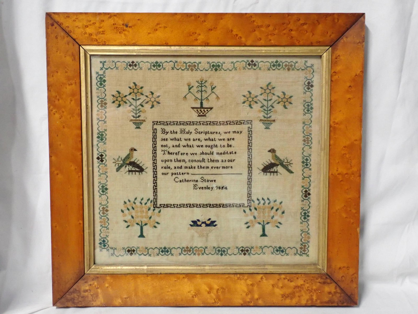 1854 Catherine Stowe Sampler: Catherine Stowe Evenley 1854 Religious verse in center. Motif birds flowers and trees. Border decorative border. Fabric loss and fabric discoloration. Frame 14 3/4" x 15 1/4" Sampler 11 1/2" x 12 1/2"