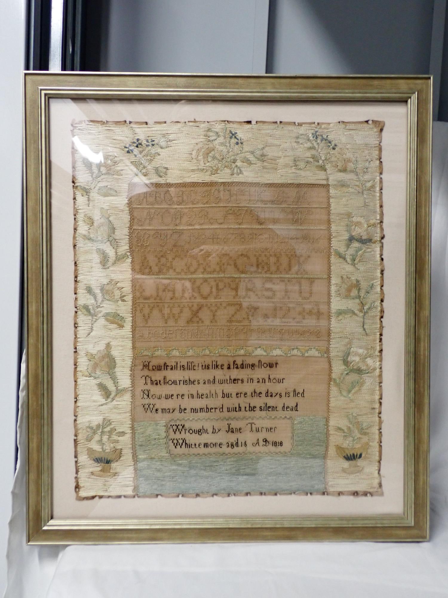 1818 Jane Turner Sampler: Wrought by Jane Turner Whittemore aged 15 AD 1818. Very nice border in crewel work depicting floral design. Middle is sampler with alphabet and numbers Short verse. Frame 24" x 20 1/2" Sampler 19" x
