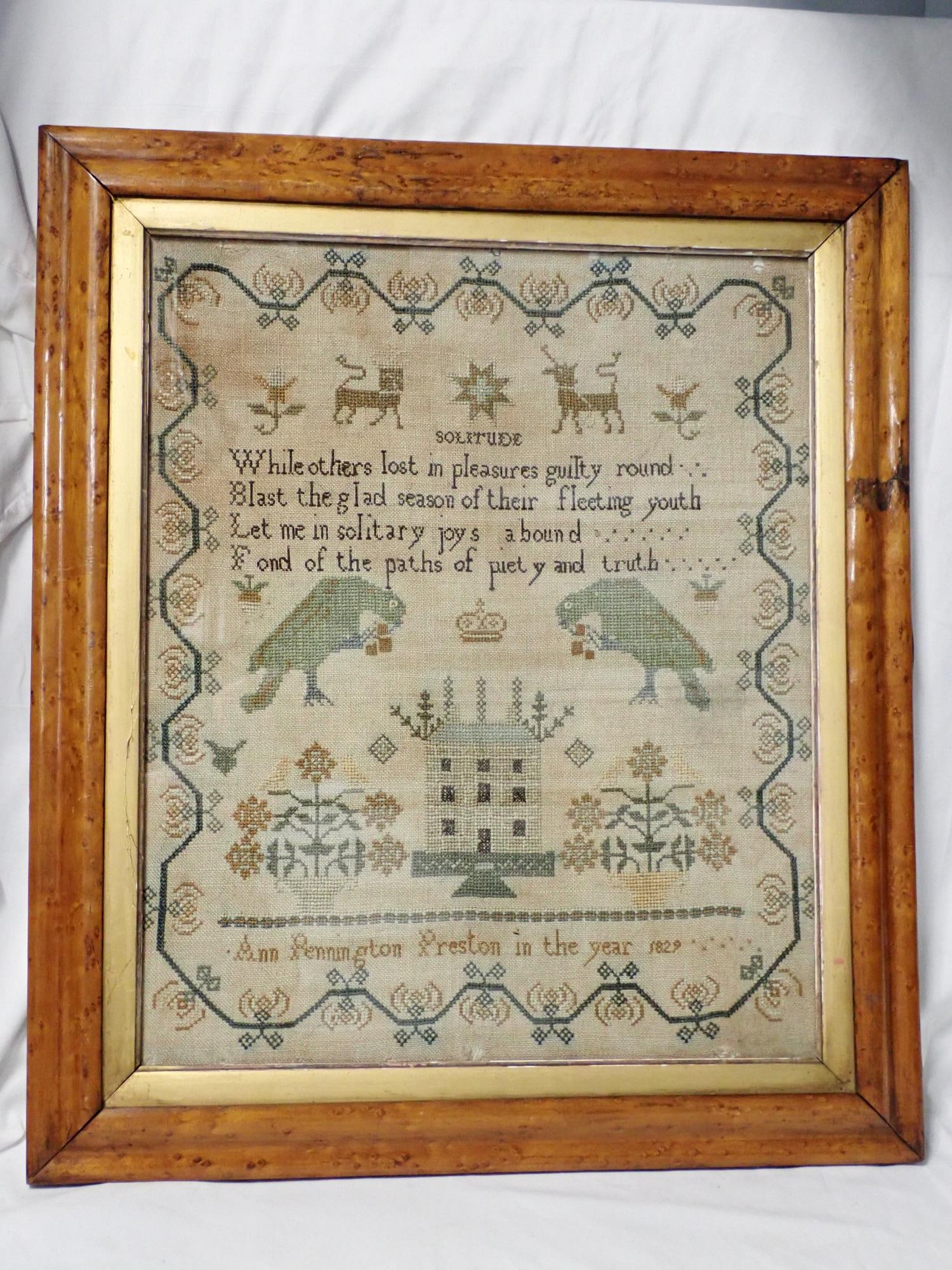 1829 Ann Pennington Preston Sampler: Ann Pennington Preston in the year 1829. Solitude verse in center. Some fabric loss and discoloration Motif Birds, Animals, building. Vince and geometrical border Frame 21" x 18 1/2" Needlework 17" x