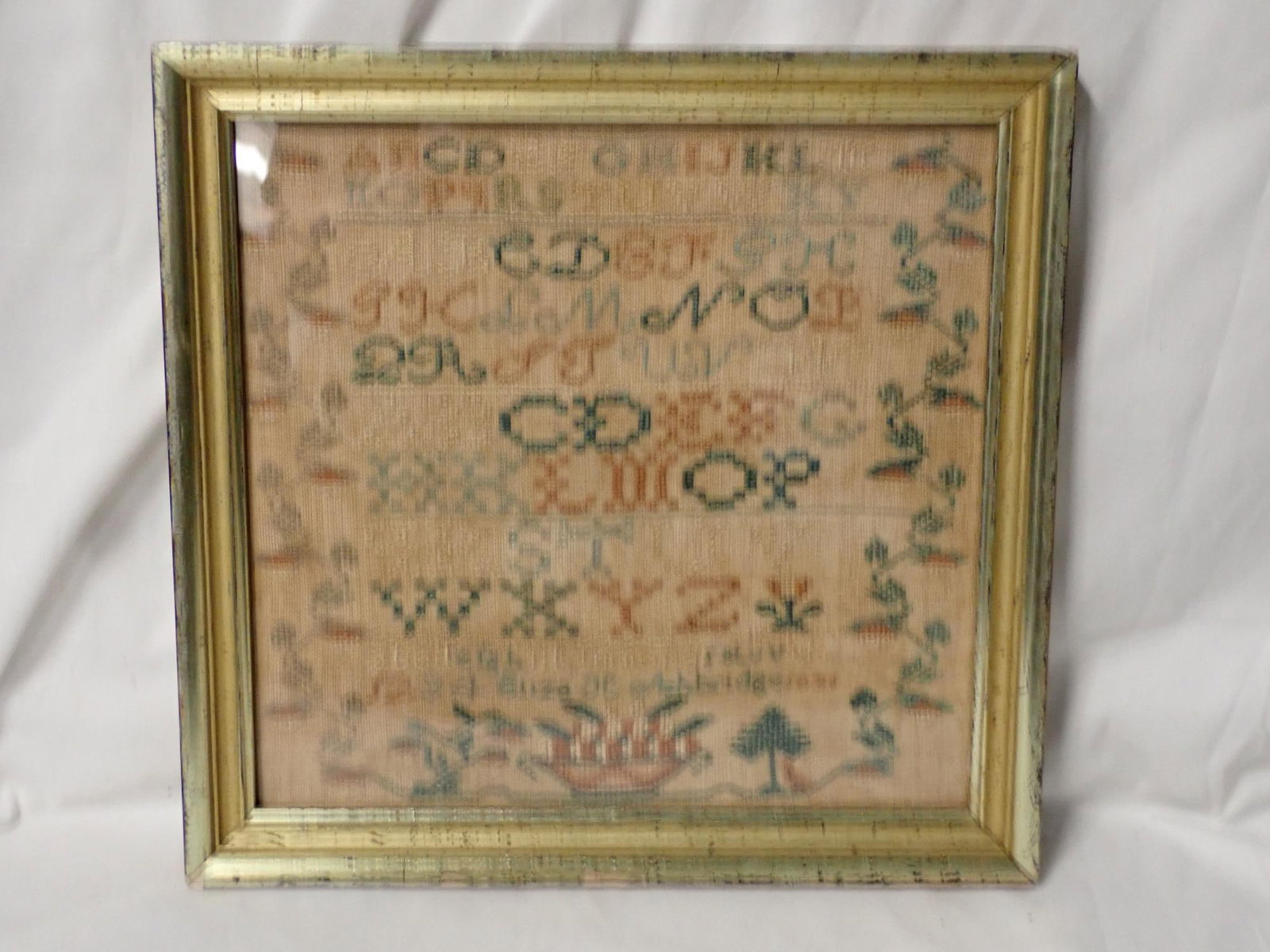 1831 Eliza Ashbridge Sampler: Eliza H Ashbridge 1831 . Motif is alphabet with a vine and flower border. Some discoloration and fading. frame 12 1/4" x 12 1/2" Sampler 10 1/4" x 10 3/4"