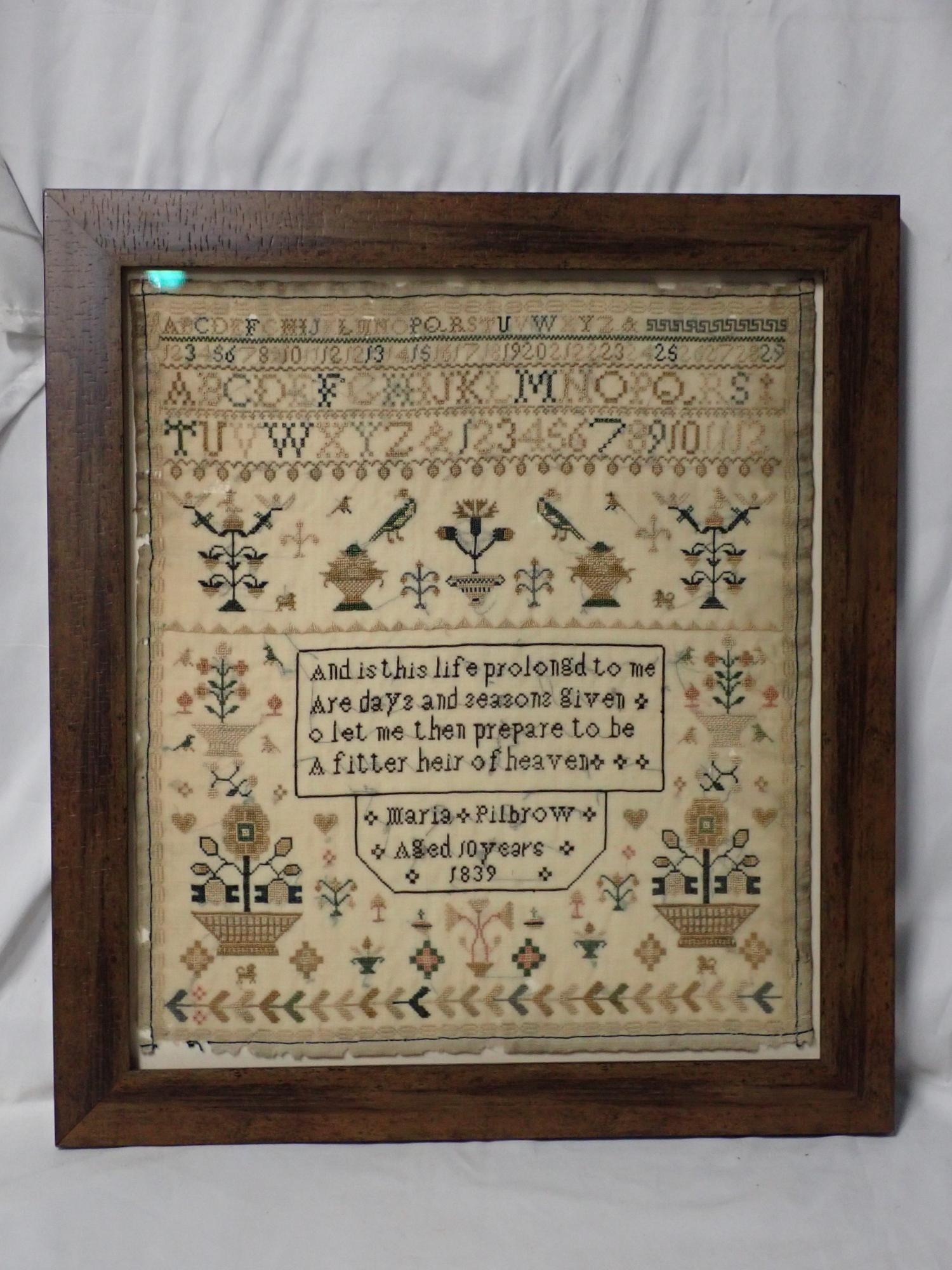 1839 Maria Pillbrow Sampler: Maria Pillbrow Aged 10 years 1839 short verse in center. Motif floral and fauna with a geometrical border. Some fabric loss, fading and discoloration. Frame 17 1/2" x 15 3/4" Sampler 14 1/4" x 12 1/2"