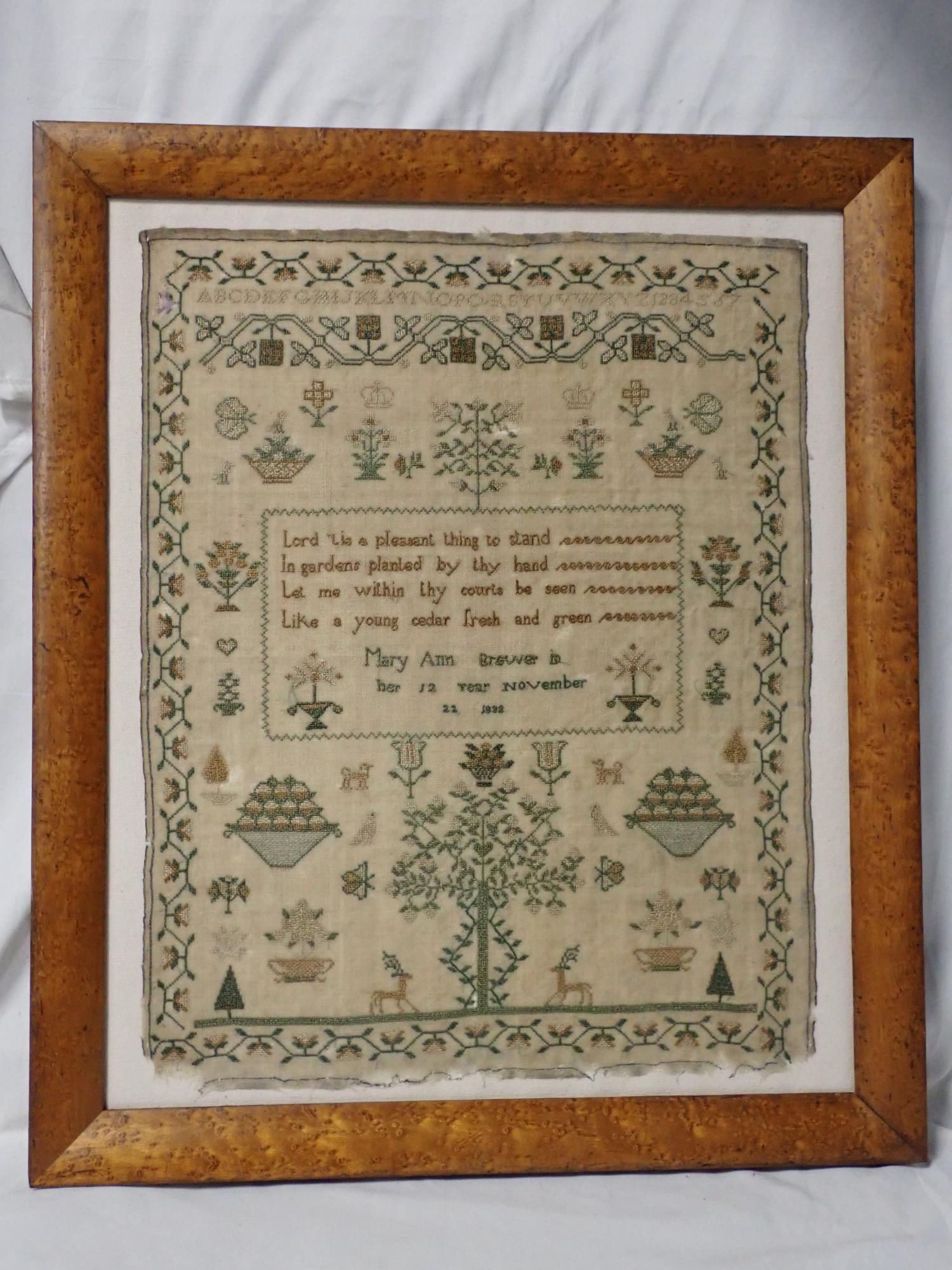 1832 Mary Ann Brewer Sampler: Mary Ann Brewer in her 12 Year November 22 1832 Religious verse in center. Depicting Alphabet and numbers, motif flora and fauna vine and flower border. Some fabric loss, fading and discoloration.