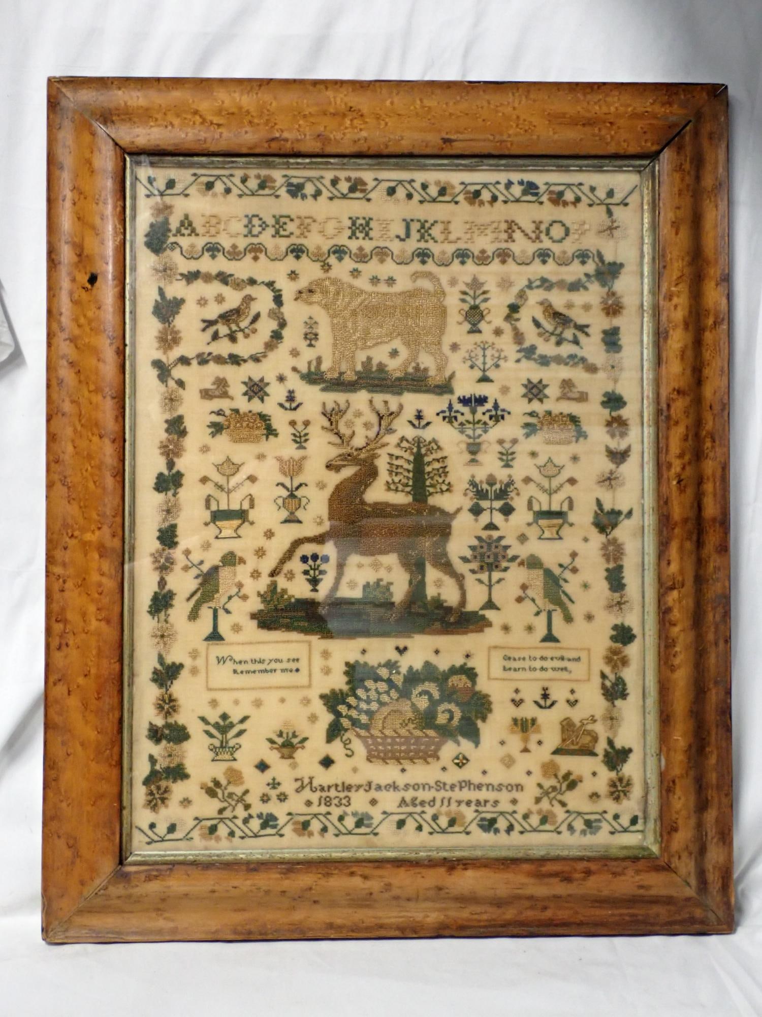 1833 Hartley Jackson Stevenson Sampler: Hartley Jackson Stevenson 1833 Aged 11 years(rare male sampler). Partial alphabet Motif is a large mastiff, stag with birds, urns of flowers Floral border. 2 short verses lower center. Some
