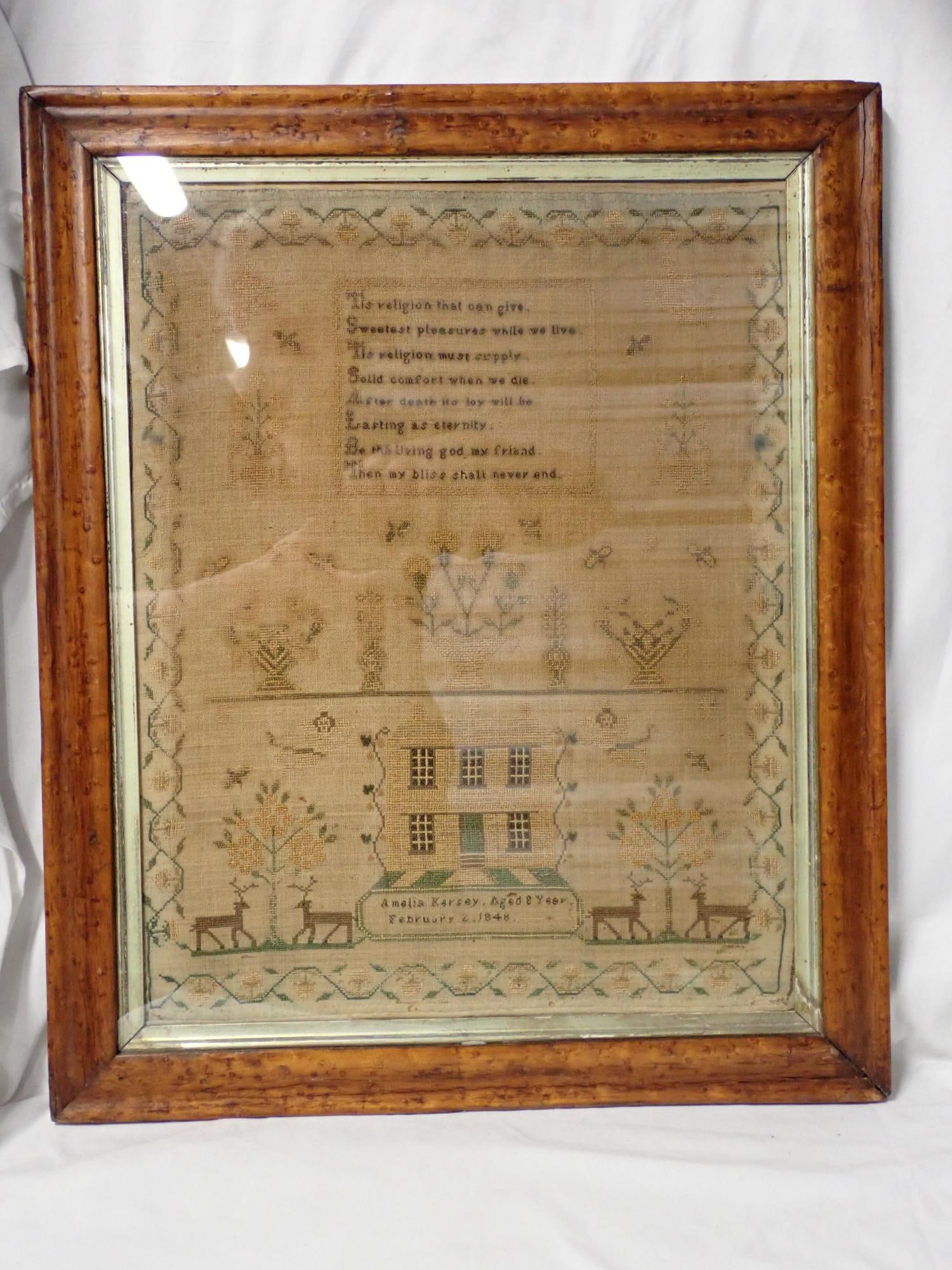 1848 Amelia Karsey Sampler: Amelia Karsey Aged 8 Year February 3, 1848. Religious verse top. Motif flowers ,cherubs house border vine and flower. Fabric discoloration and fading Frame 20 3/4" x 17 1/4" Needleword 16 1/2" x 13"