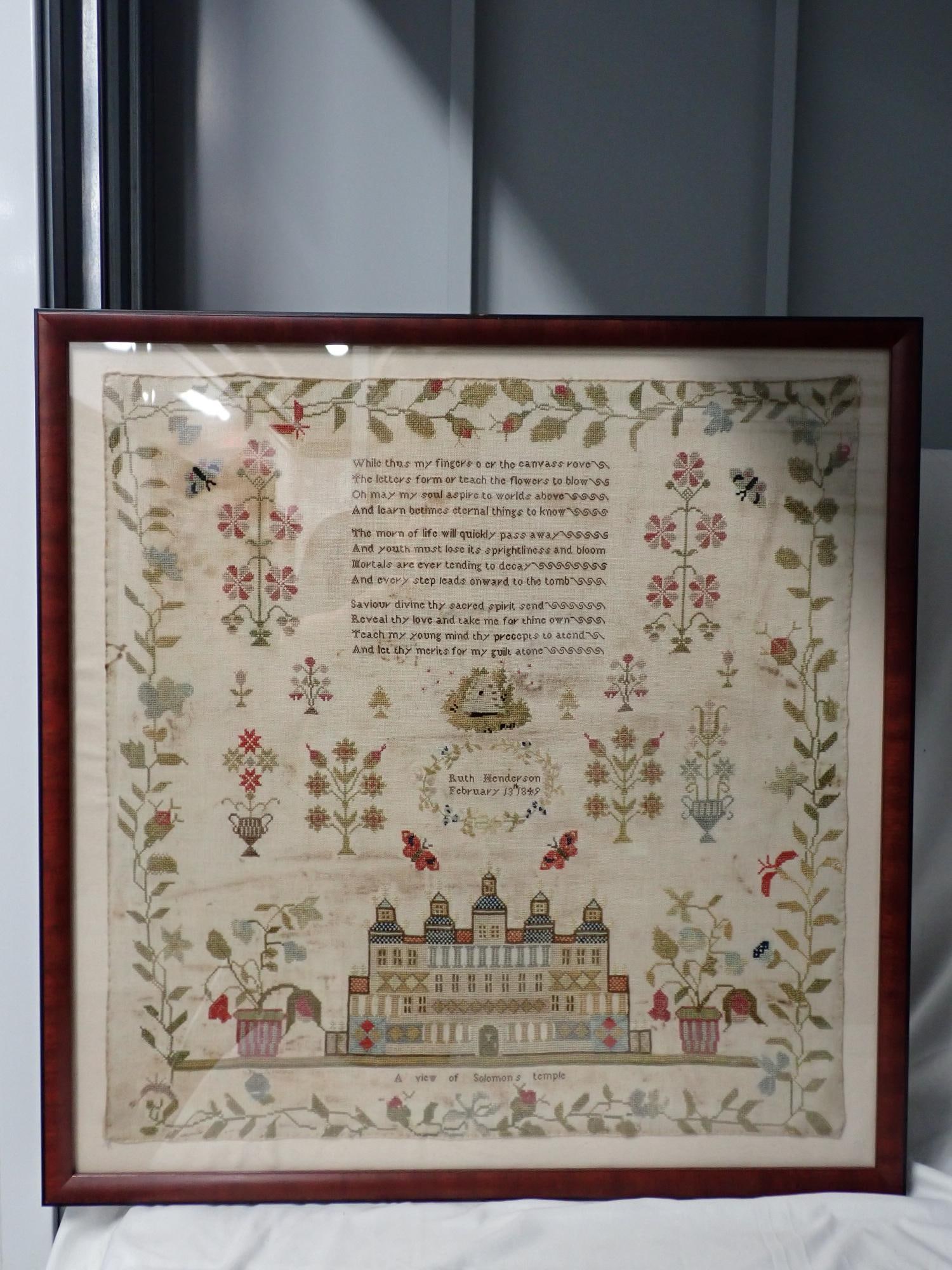 1849 Ruth Henderson Sampler: Ruth Henderson February 13 1849. motif: a view of Solomon's temple. butterflies, flowers - appears to be a beehive with bees in center. Verse at top. Vine and floral border, Some discoloration Frame