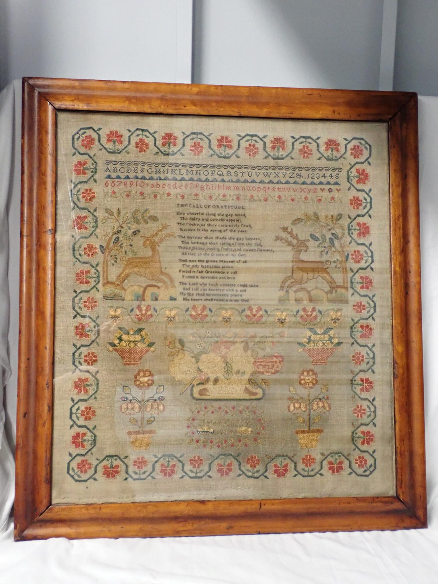 1894 Helen Clifton Sampler: Helen Clifton 1894 Religious verse The Call of Gratitude. Alphabet, Deer, floral design vine and flower border design Bright colors, some fabric discoloration Frame 24 3/4" x 22 1/2" Sampler 21" x 18