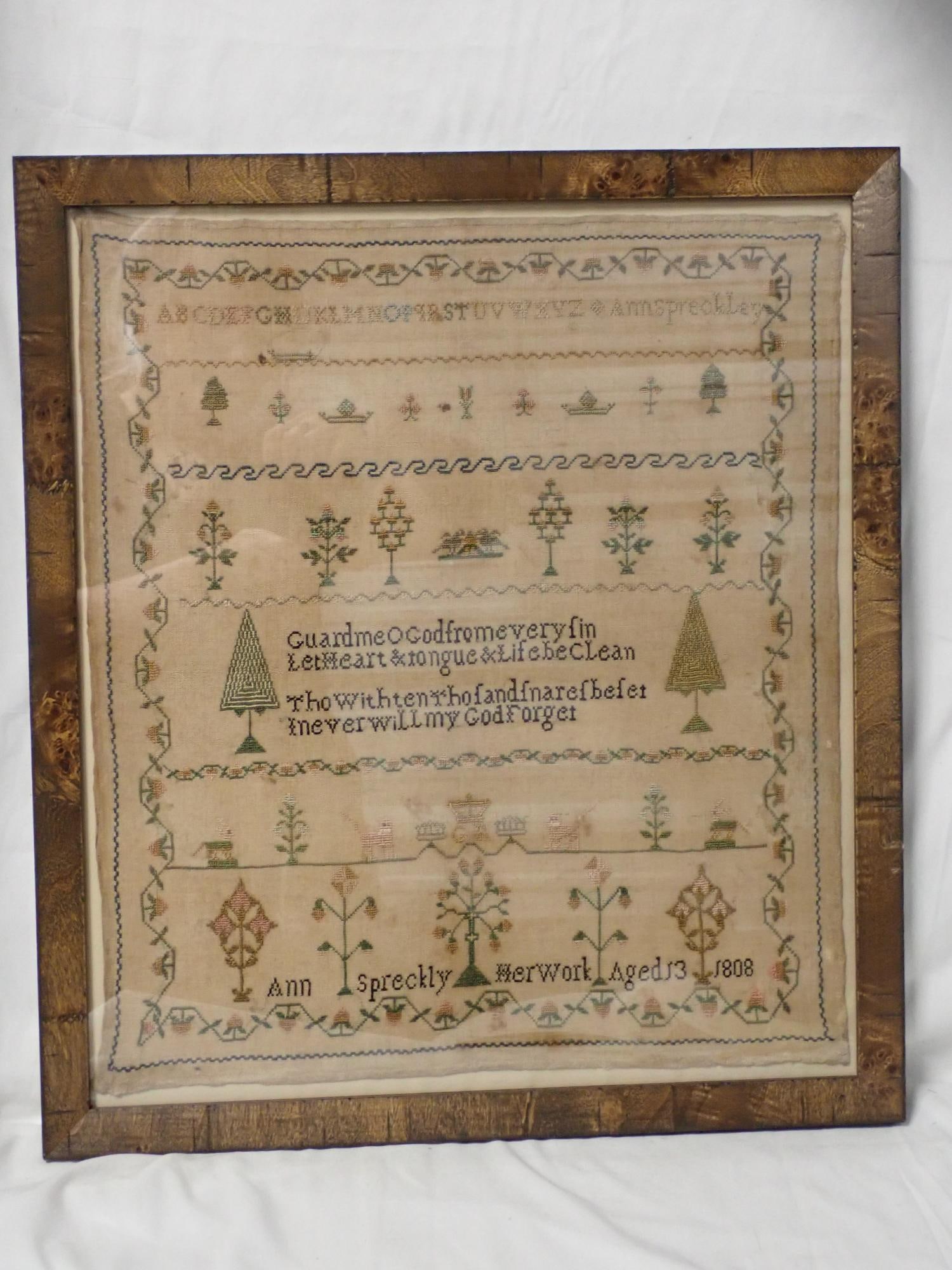 1808 Ann Spreckly Sampler: Ann Spreckly Her Work Aged 13 1808. Alphabet. Religious verse in center motif flowers trees animals vine and floral border \Some fabric loss along edges, fabric discoloration and fading. Frame 19 3/4"