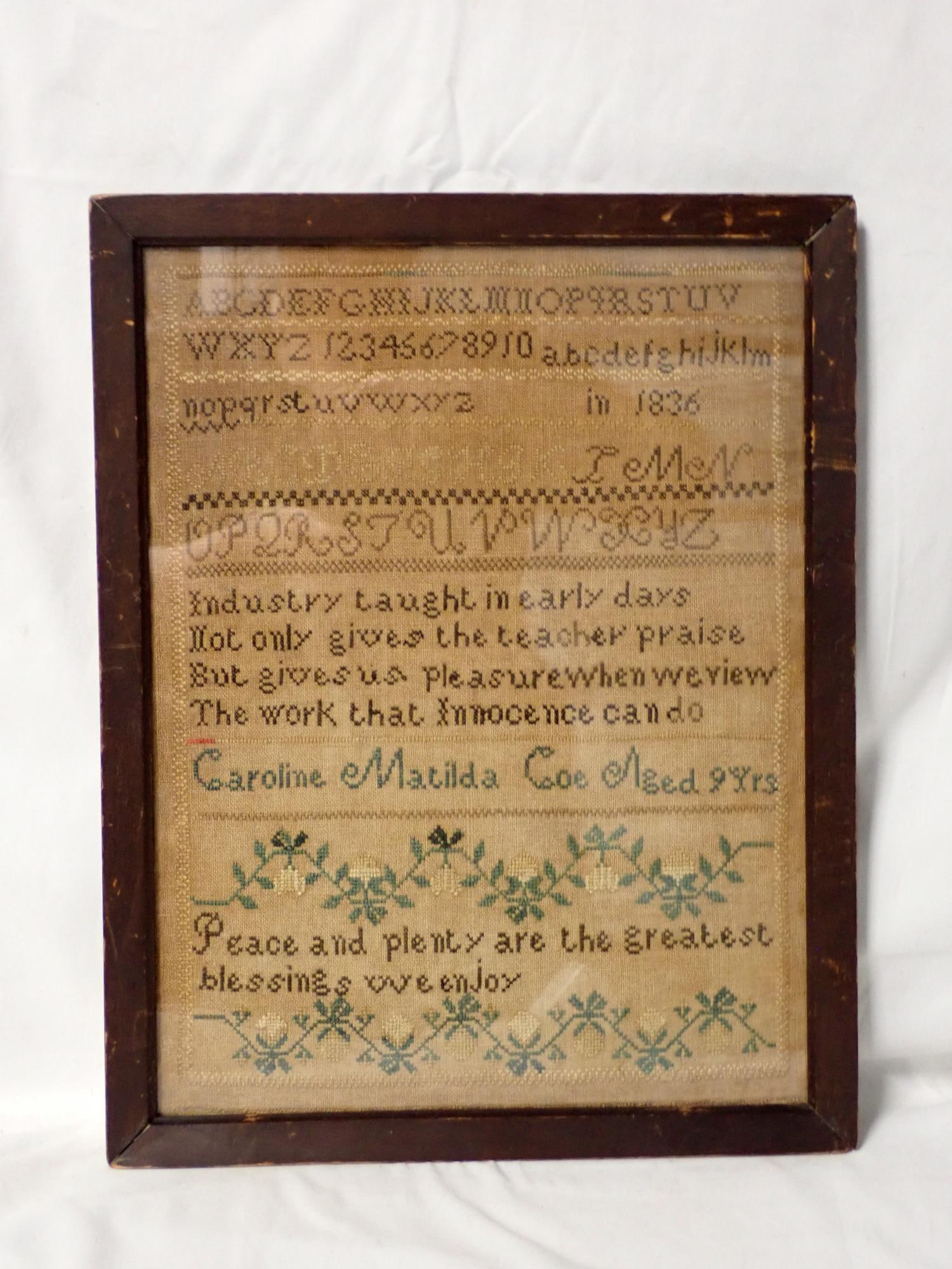 1836 Caroline Matilda Coe Sampler: Caroline Matilda Coe Aged 9 Yrs. Alphabet, numbers and 2 vrse middle and bottom. Vine and floral design. Some discoloration Frame 14" x 11." Sampler 12 1/2" x 9 1/2"