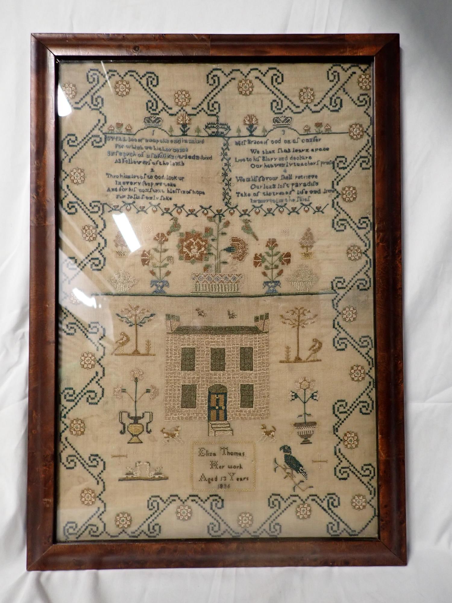 1836 Eliza Thomas Sampler: Eliza Thomas Her Work Aged 13 Years 1836. 4 numbered religious verse at top. motif flora and fauna, animals house stylized vine and flower border. Some fabric loss and discoloration. Frame 21 1/2" x 1