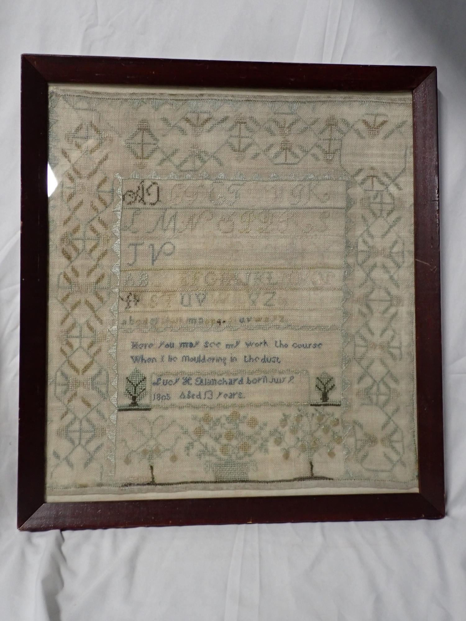 1805 Lucy Blanchard Sampler: Lucy H Blandford born July 8 (?) 1805 Aged 13 years. Partial Alphabet fabric and thread fading. Geometrical border short verse in middle, some flowers, may be incomplete. Frame 19 1/2" x 17 1/2"