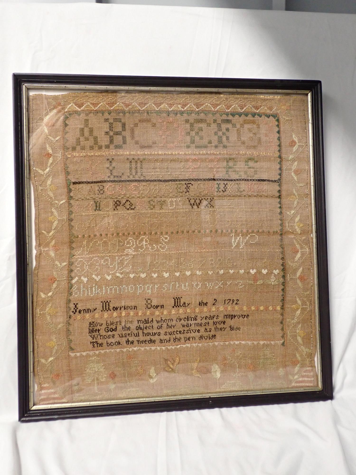 19th Jenny Morrison Sampler: Jenny Morrison Sampler with verse May 18th . Motif floral and birds and trees. fabric fading and thread loss. Fabric loss on edges. Frame 19 1/4" x 18 1/4" Sampler 17 3/4" x 16 1/2"