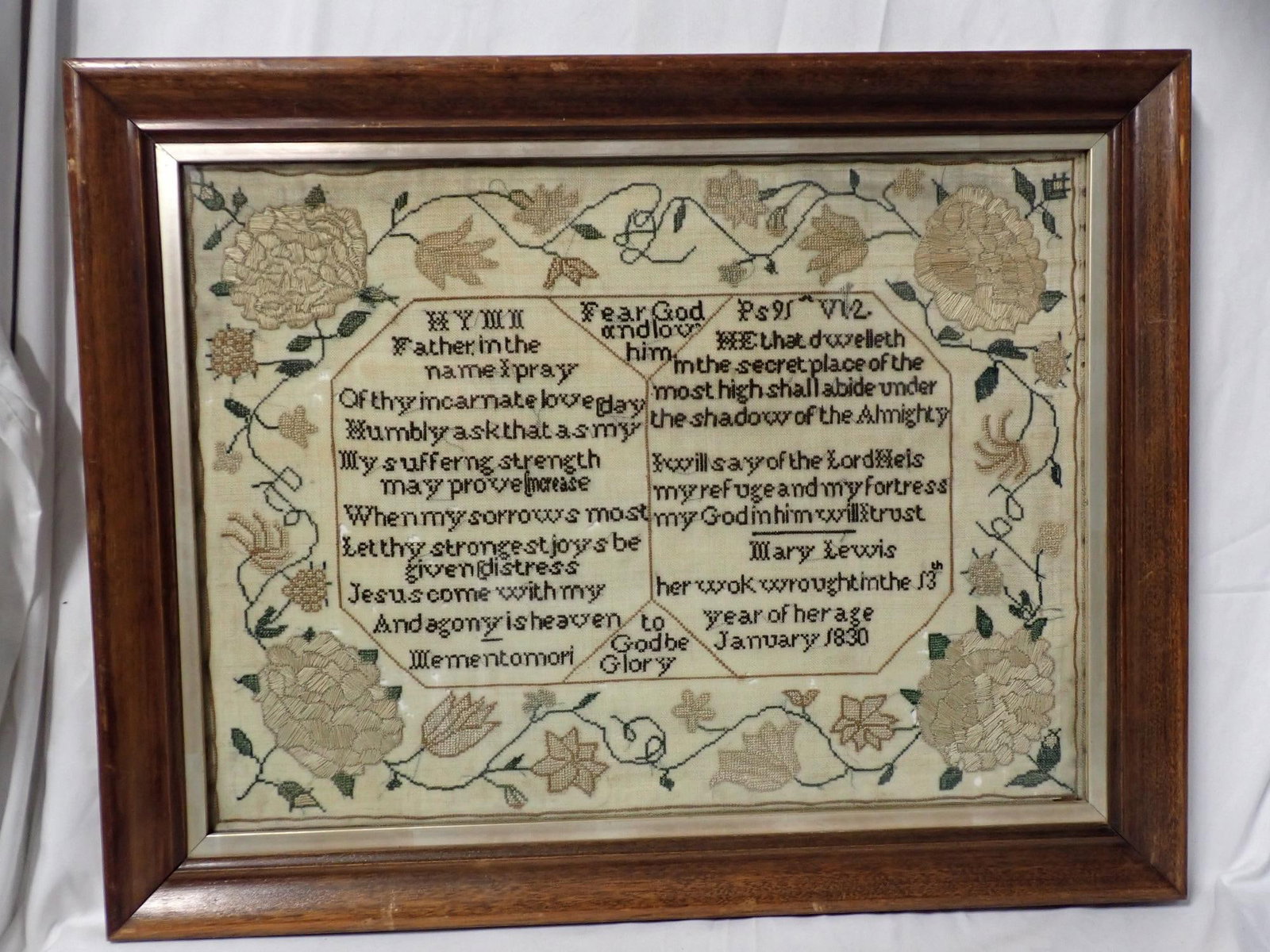 1830 Mary Lewis Sampler: Mary Lewis her work wrought in the 13th year of her age January 1830 Religious verse in center with floral large border includes some crewel work. Fabric Loss Frame 16" x 20 1/2" Sampler 12 1/2" x 16 