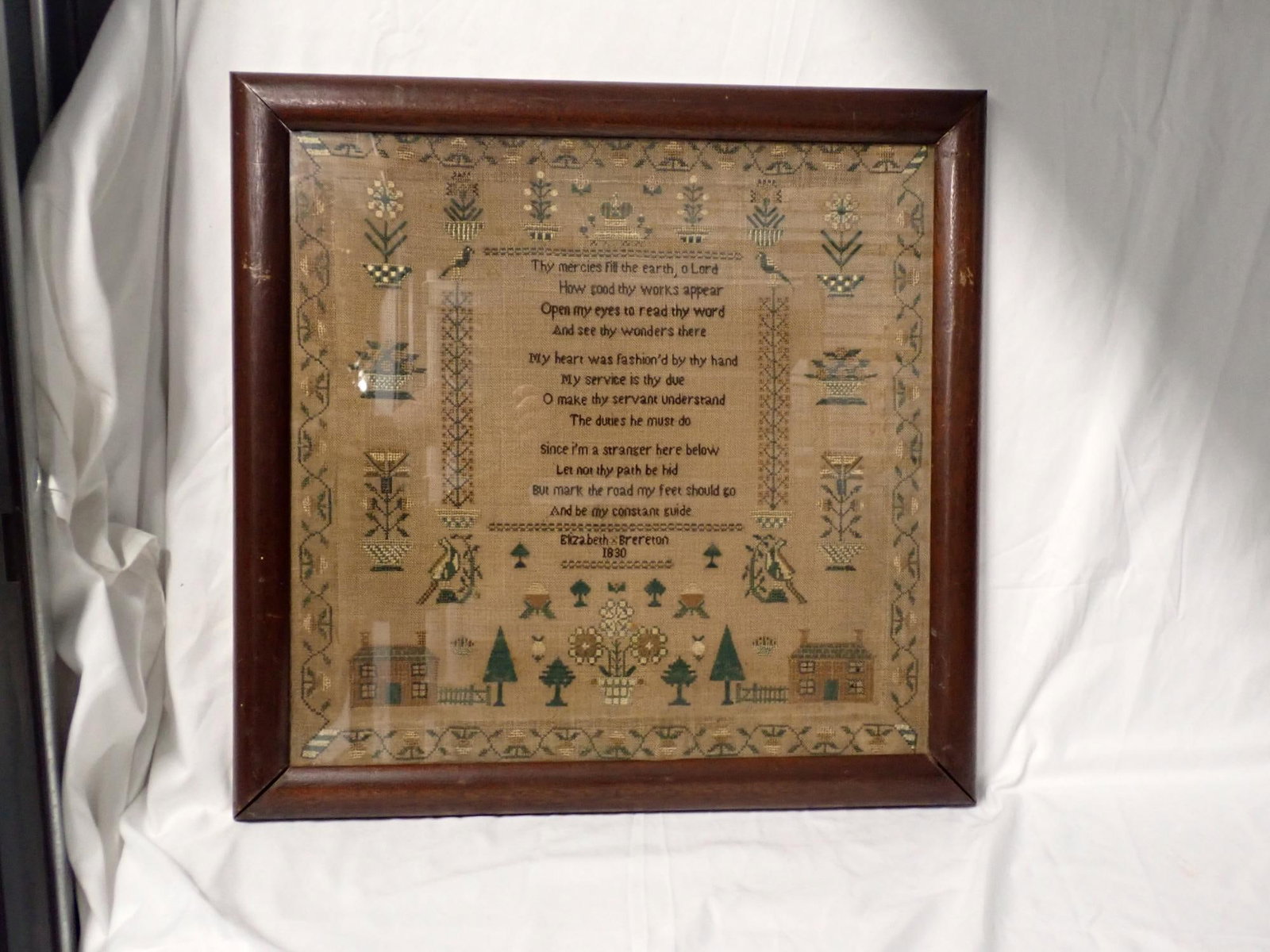 1830 Elizabeth Brerreton Sampler: Elizabeth Brerreton Sampler religious verse in center motif is floral birds homes and trees. Floral and vine border. Fabric is discolored uniformly Frame 20" x 20 1/2" Sampler 16 3/4" x 17 1/4"