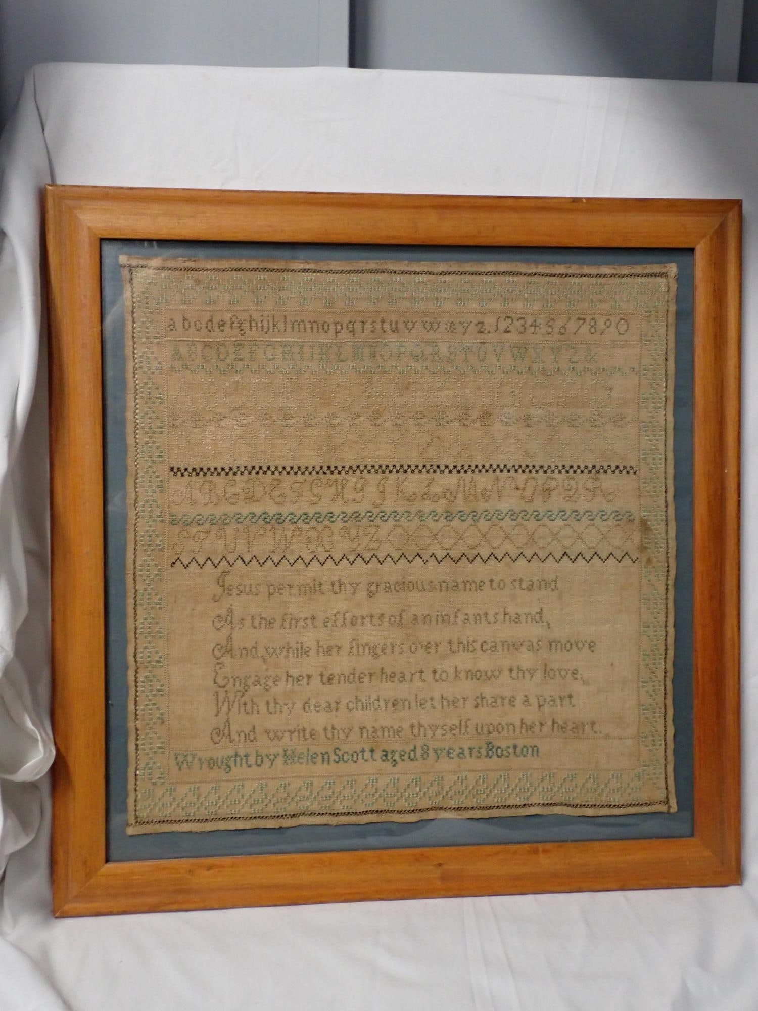 Helen Scott Sampler: Helen Scott aged 8 years Boston motif alphabet numbers some of the alphabet is done in the eyelet stitch. Religious verse on bottom Fabric staining and discoloration, Frame 20 1/2" x 20 1/4"Sampler 16
