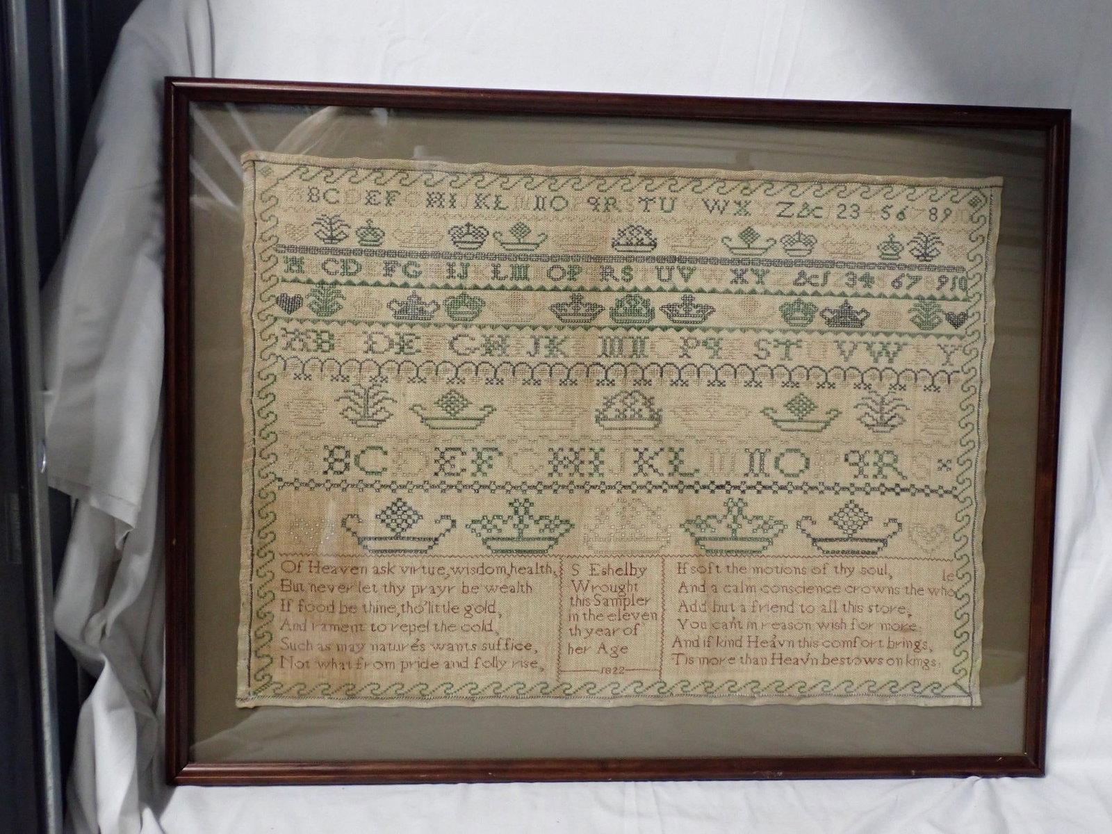 1822 S Eshelby Sampler: S Eshelby Wrought this Sampler in the eleventh year of her Age 1822 Motif alphabet numbers crowns geometrical designs. Use of some eyelet stitching. Religious verses on bottom. Fabric discoloration