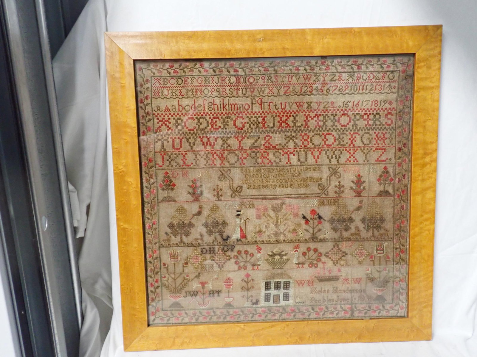 1838 (?) Helen Henderson Sampler: Helen Henderson Peebles June 6 (?) 1838 )?)Alphabet and numbers. Short verse in center. Shepherd, birds, floral design. Vine and floral border. Some fabric discoloration. Frame 20 1/2" x 20 1/2" Sampl