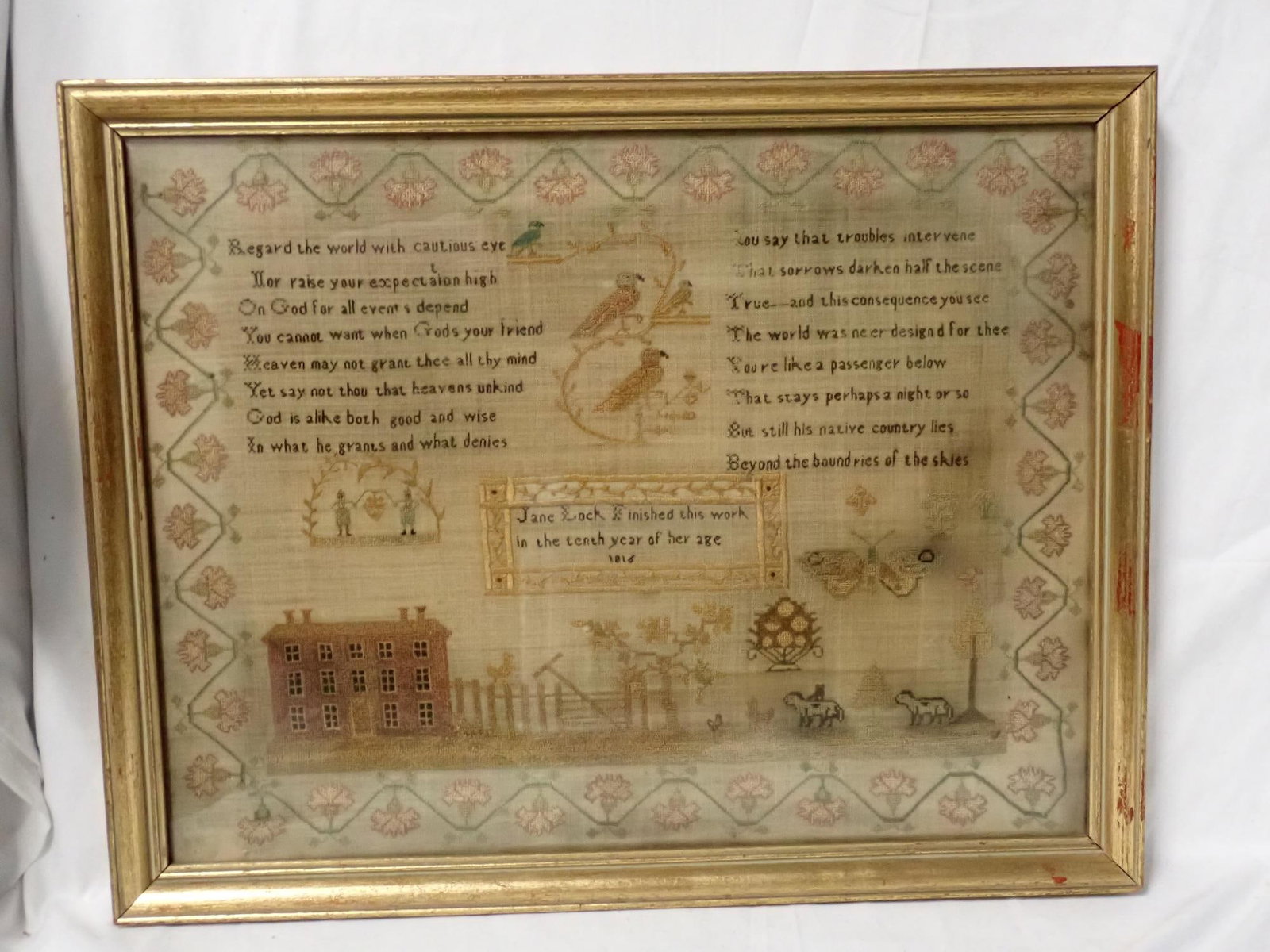 1816 Jane Lock Sampler: Jane Lock Finished this work in the tenth year of her age 1816 Religious verse at top. Motif birds, people, possibly a farmhouse, fence trees, animals. Vine and floral border . Some thread loss,