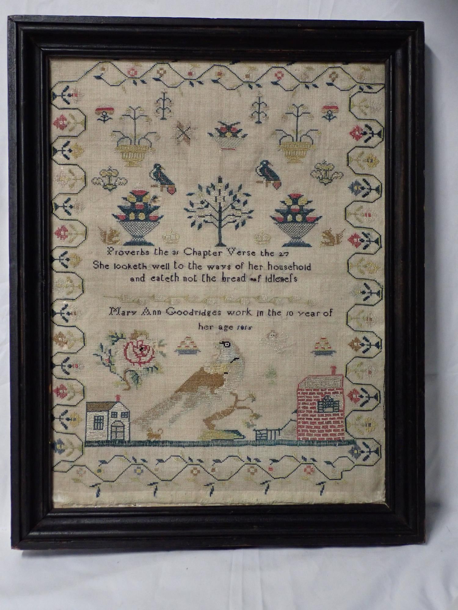 1855 (?) Mary Ann Goodridges Sample: Mary Ann Goodridges work in the 10 year of her age 1855 (?). Religious verse in center. Motif Birds, floral baskets, houses. Floral border Frame 19 1/4" x 15 1/4" Sampler 16 3/4" x 12 1/2" no glass
