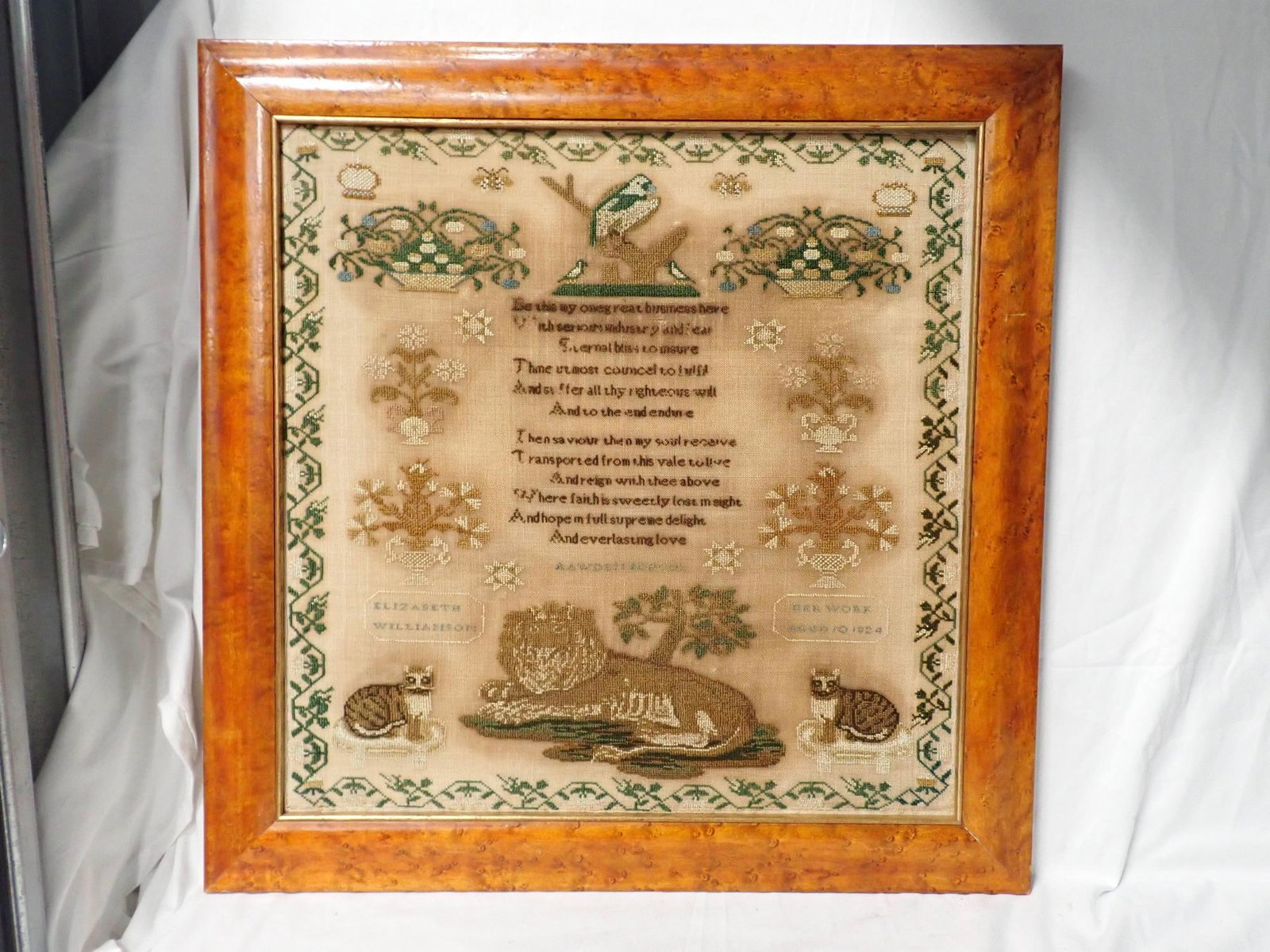 1824 Elizabeth Williamson Sampler: Elizabeth Williamson Her work Aged 10 1824. Verse center Motif flora, birds l with lion and cats border vine and flowers. Fabric discoloration. Frame 21 1/4" x 21" Sampler 17" x 17" no glass