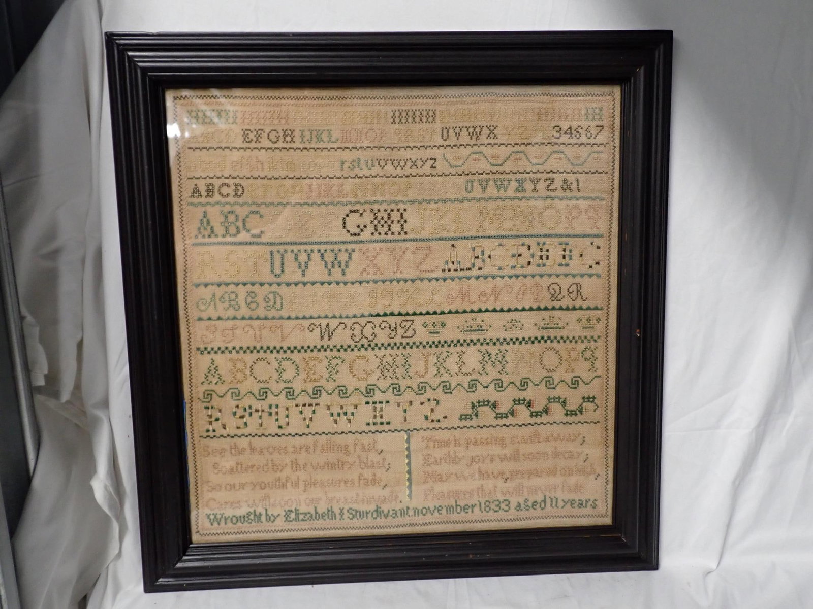 1833 Elizabeth Sturdivant Sampler: Wrought by Elizabeth Sturdivant November 1833 aged 11 years. Alphabet and numbers, Geometrical designs throughout. Some fading of threads. Frame 21 1/2" x 21" Sampler 17" x 16 1/2" Verse at bottom