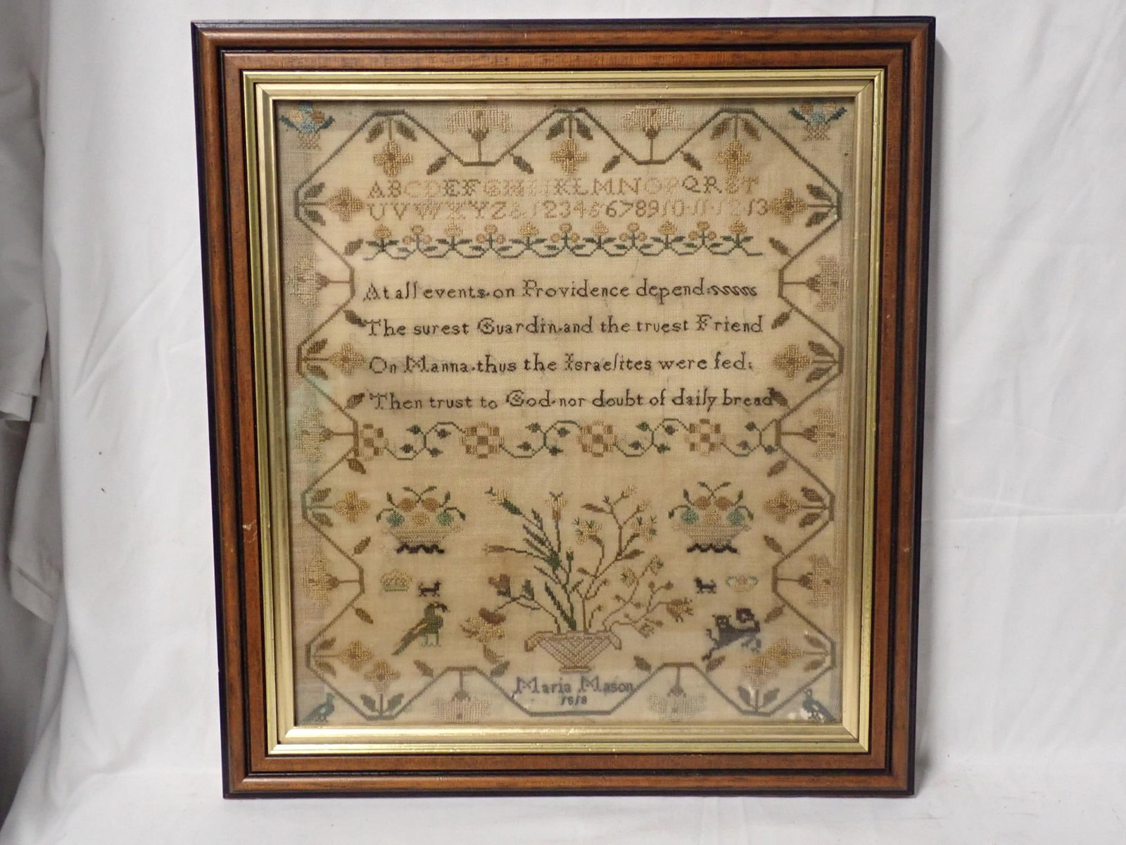 1818 Maria Mason Sampler: Maria Mason 1818 Alphabet numbers, floral animals and birds. Vine and floral border. Some fabric loss and fabric discoloration Frame 15 1/2" x 14 1/4". Sampler 12 1/2" x 11"