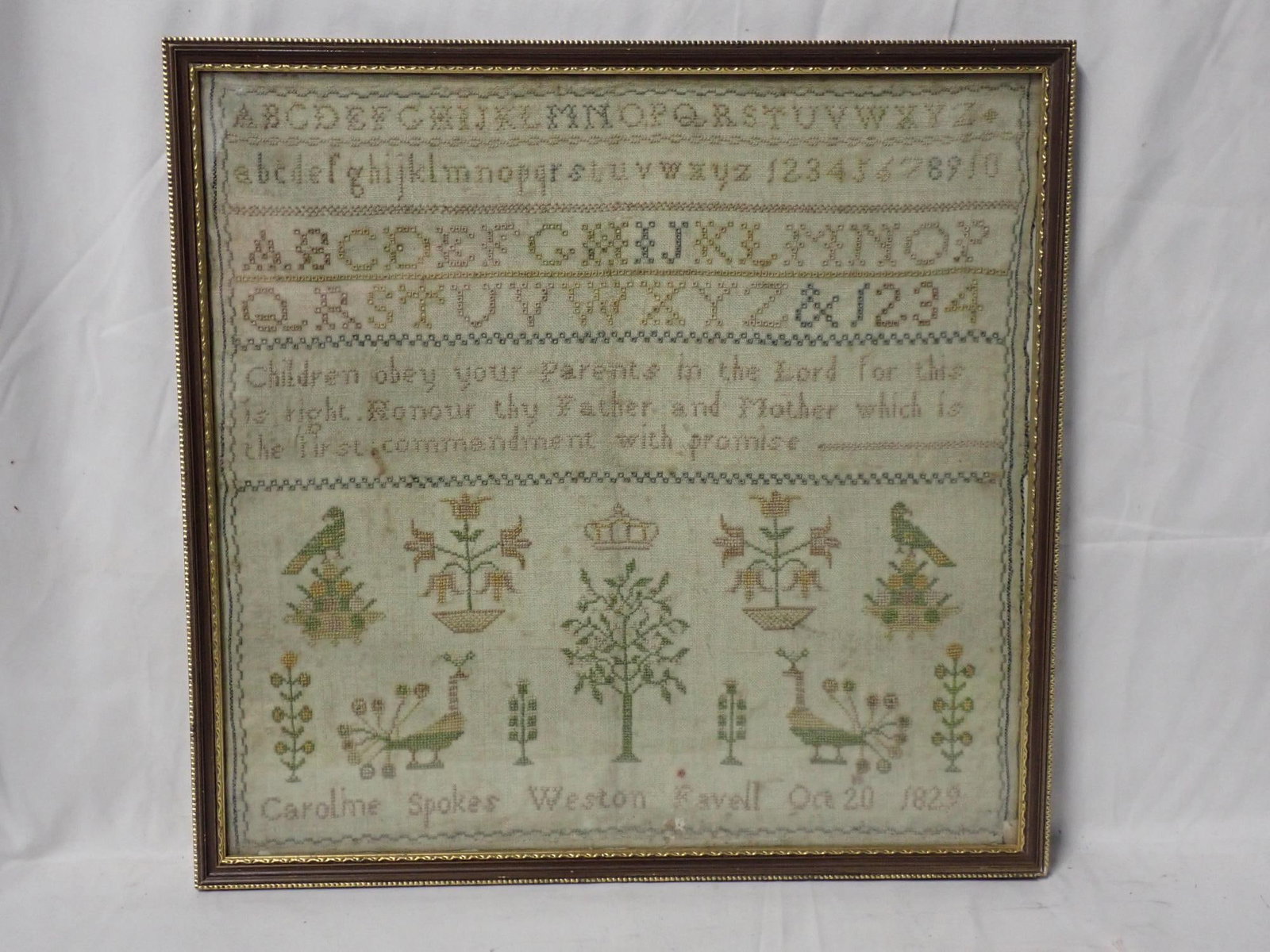 1829 Caroline Spokes Weston Favell (?) Sampler: Caroline Spokes Weston Favell (?) Oct 20th 1829. Alphabet and numbers. Religious verse in center. Motif Birds, trees and flowers. Slight fabric loss on bottom edge. some fading Frame 13 3/4" x 14