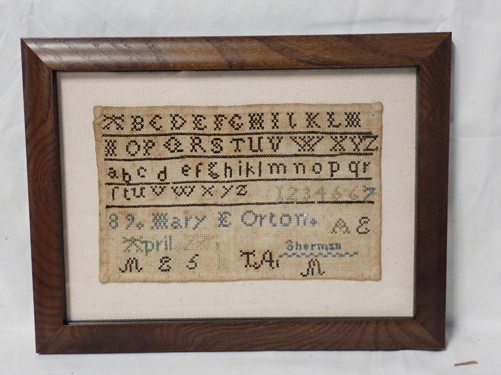 1882 (?) Mary Orton Sampler: Mary Orton AE April 27 Sherman? Alphabet and numbers. Some fading and staining. Frame 8" x 10 1/2" Sampler 4 1/2" x 7"