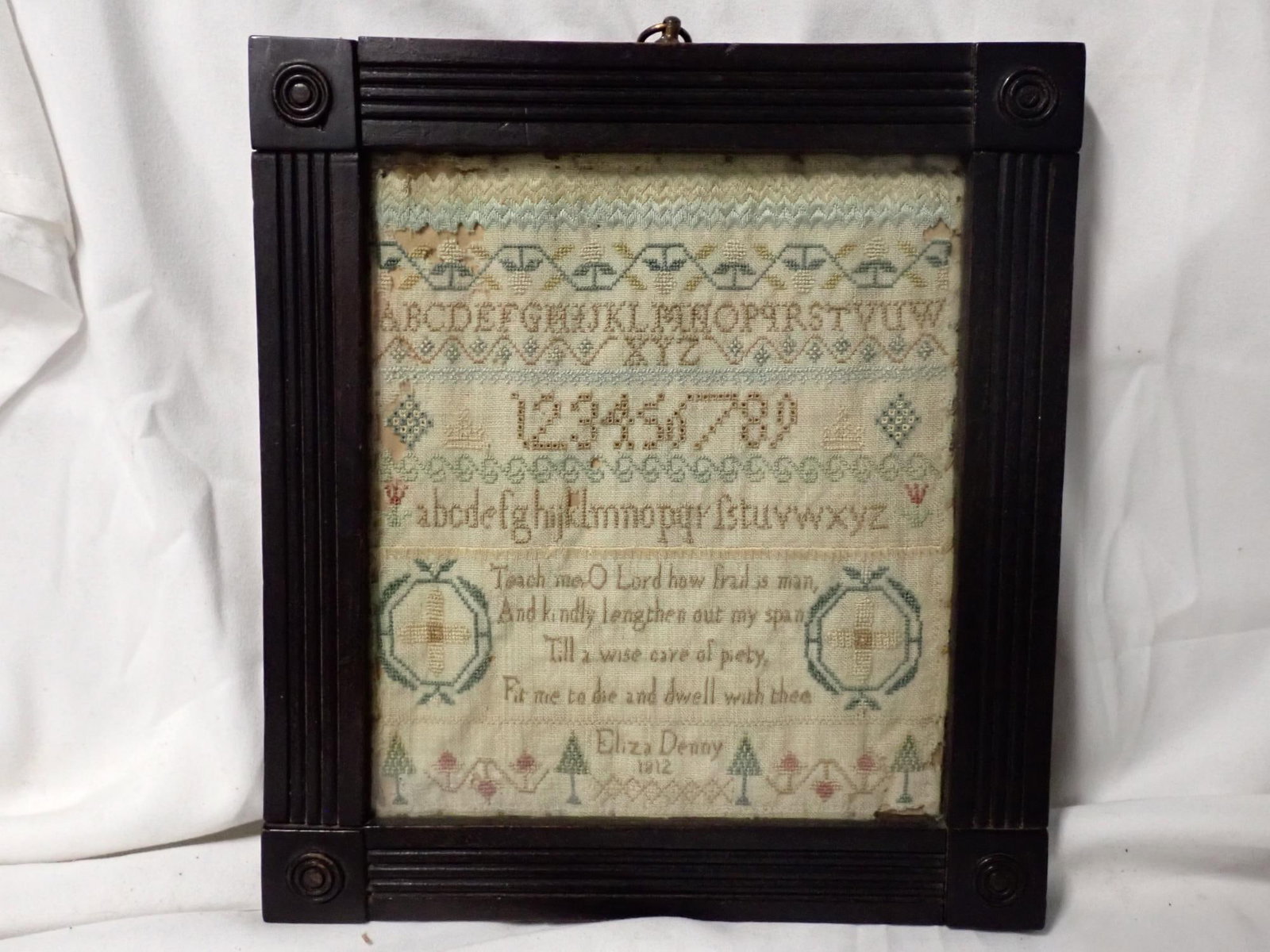 1812 Eliza Denny Sampler: 1812 Eliza Denny Religious verse in center. alphabet and numbers. Motif chevron stitch at top tres, Vine and flowers, geometrical patterns. Some fabric loss . Frame 8 1/4" x 7 1/2". Sampler 6 1/4" x