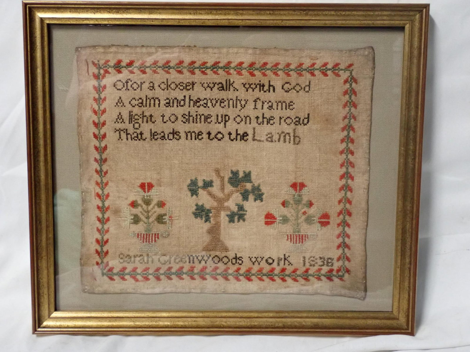 1836 Sara Greenwoods Sampler: 1836 Sarah Greenwoods work 1836 Religious verse at top. Motif is trees,urns and flowers. Vine and flower border. Some fabric discoloration. Frame 11" x 13" Sampler 8 1/4" x 9 3/4"