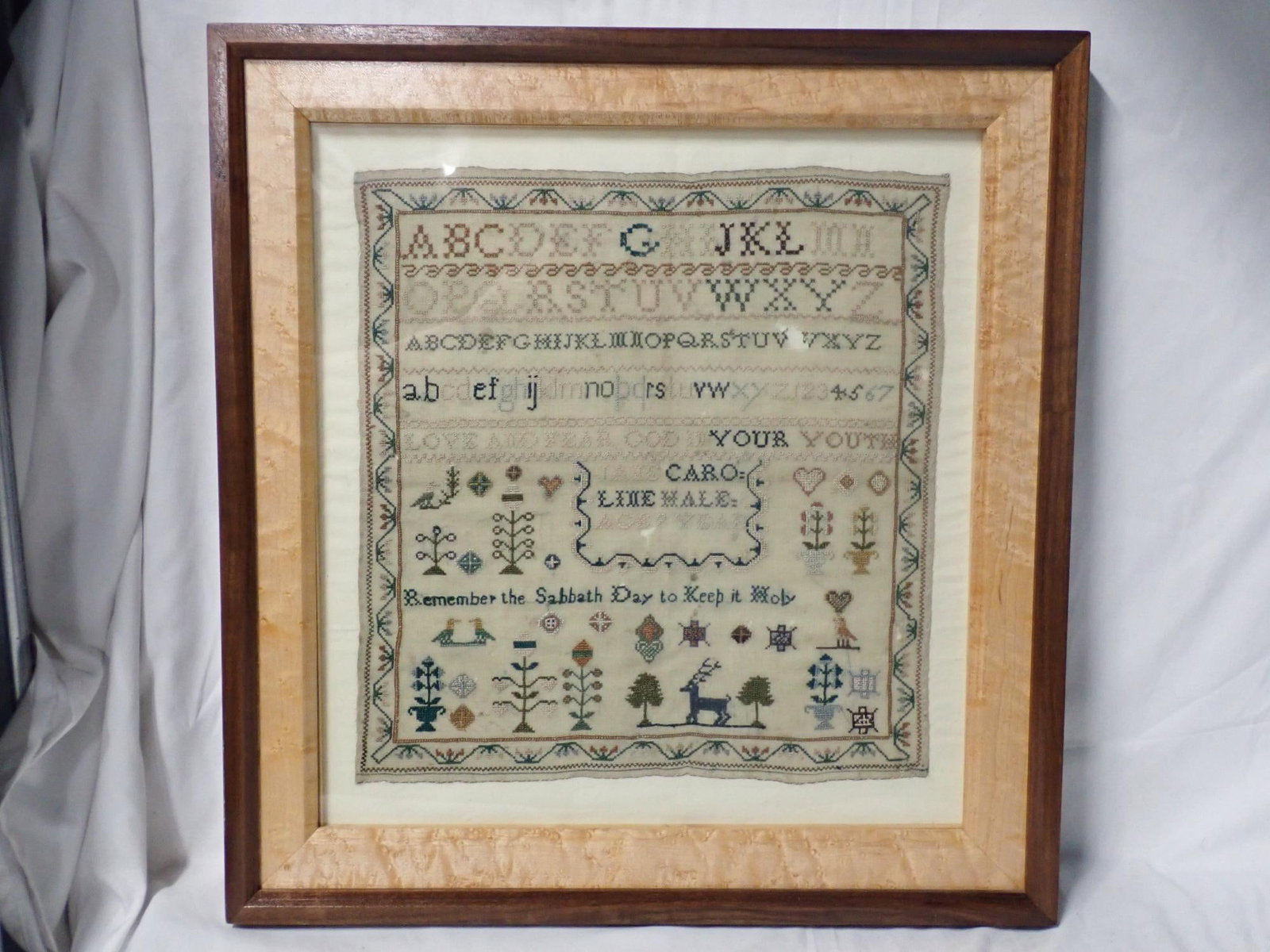 Caroline Hale Sampler: Caroline Hale Age 9 years. Alphabet and numbers. Religious verse center and bottom. Motif flowers, birds, animals VIne and floral border. Some fabric loss, discoloration. Frame 19" x 17 3/4" sampler 1