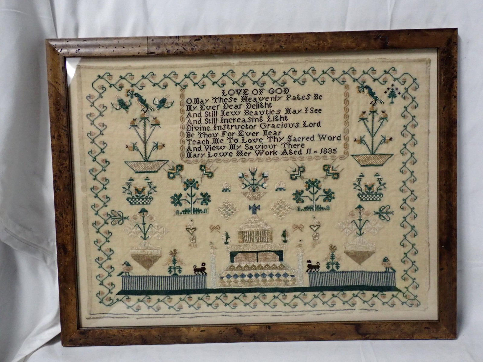 1835 Mary Lowe Sampler: Mary Lowe Her work Aged 11 1835. Religious verse at top. Motif flowers, birds, animals, building. Vine and floral border. Some fabric loss at bottom. Frame 13 1/2 x 17 1/2. Sampler 11 1/4 x 15