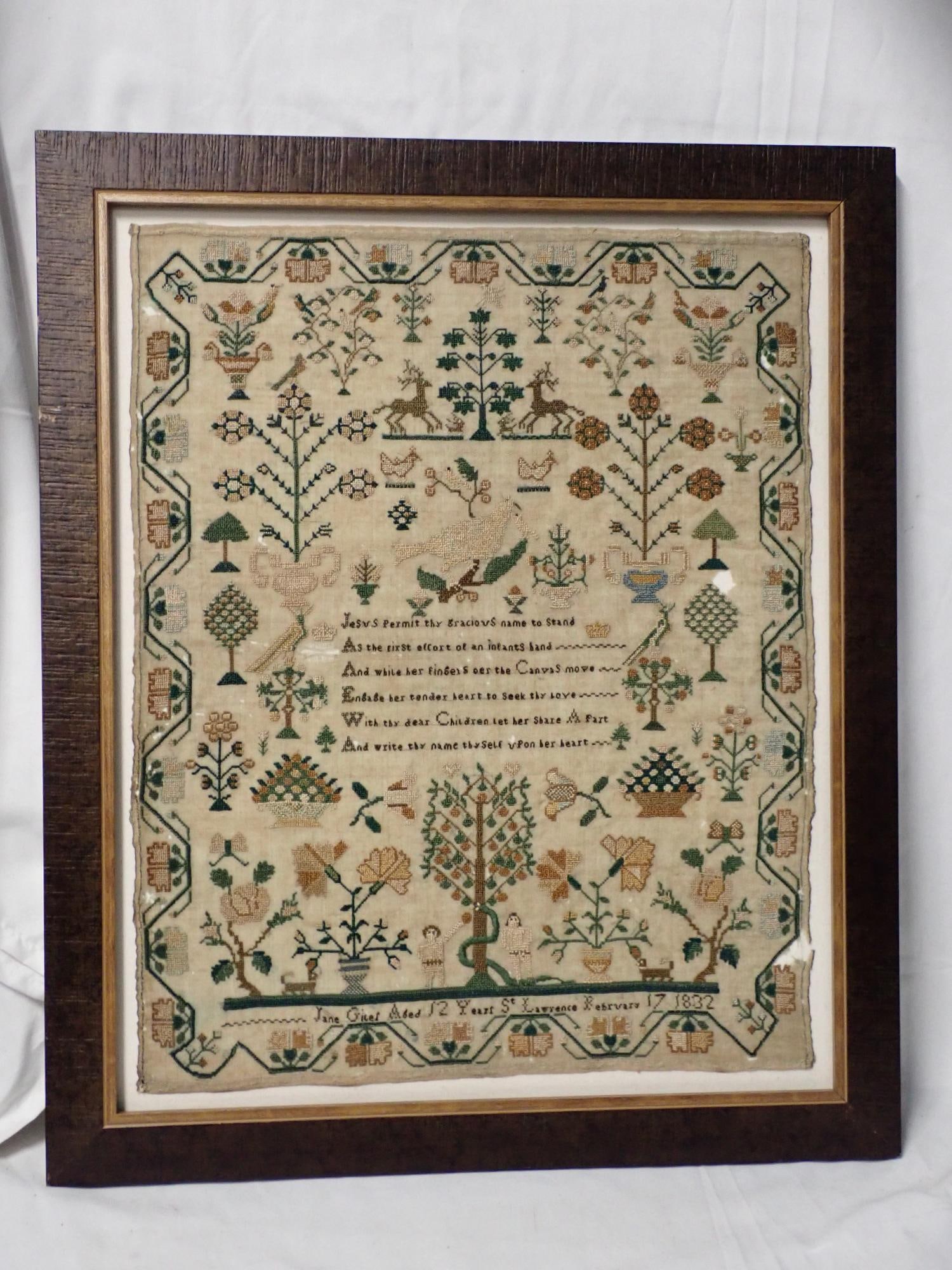 1832 Jane Giles Sampler: Jane Giles Aged 12 Years St. Lawrence February 17 1832. Religious verse in center. Motif Adam and Eve, flowers, birds baskets stags. Vine and floral border. Staining and fabric loss. Frame 19 3/4 x16 